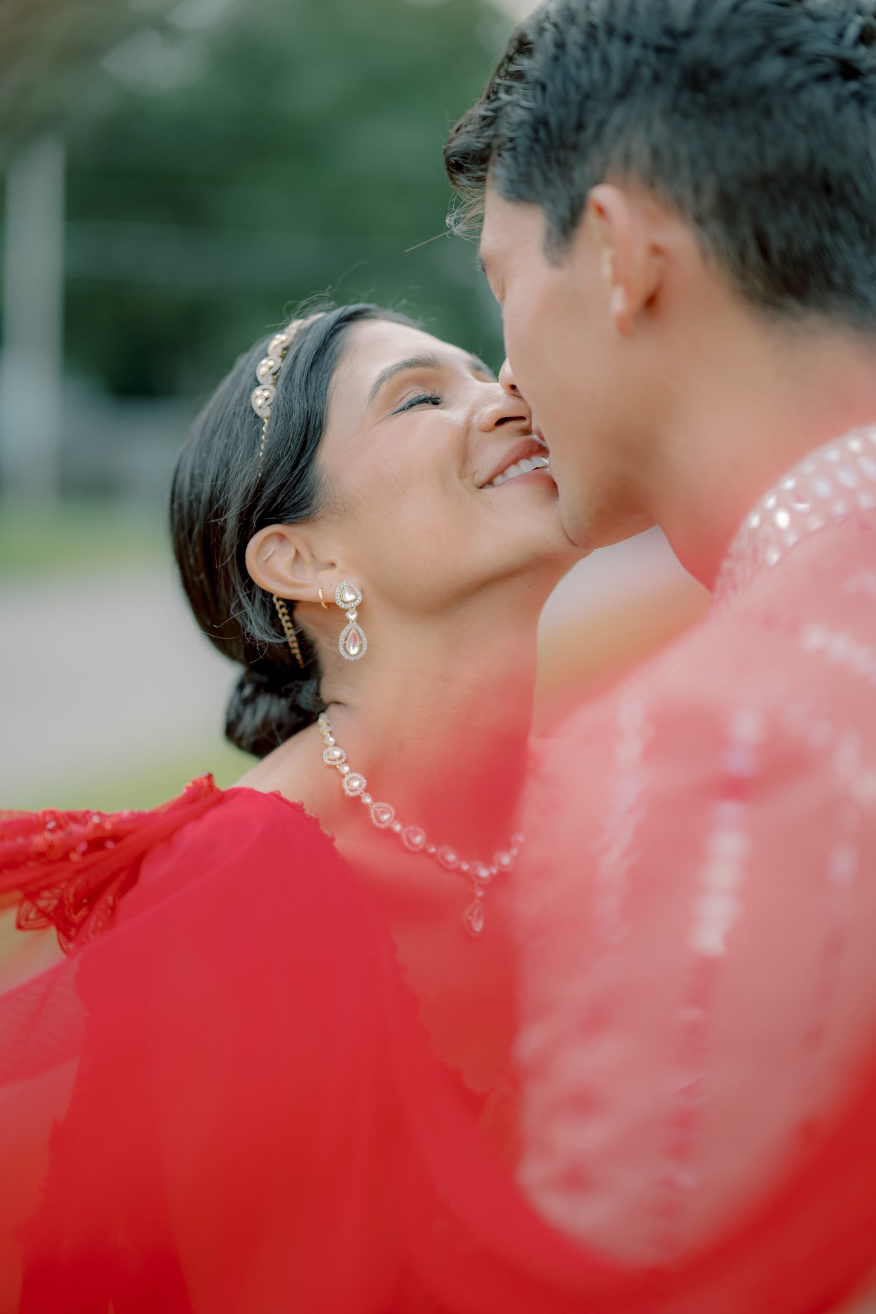 Nose to nose under a red dupatta