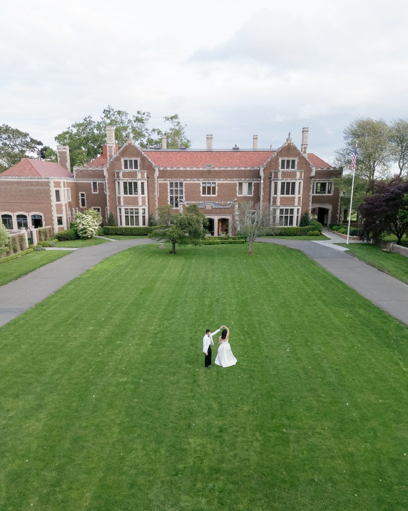 Aerial view — couple on estate lawn — wedding photography by Shukhrat Kamalov