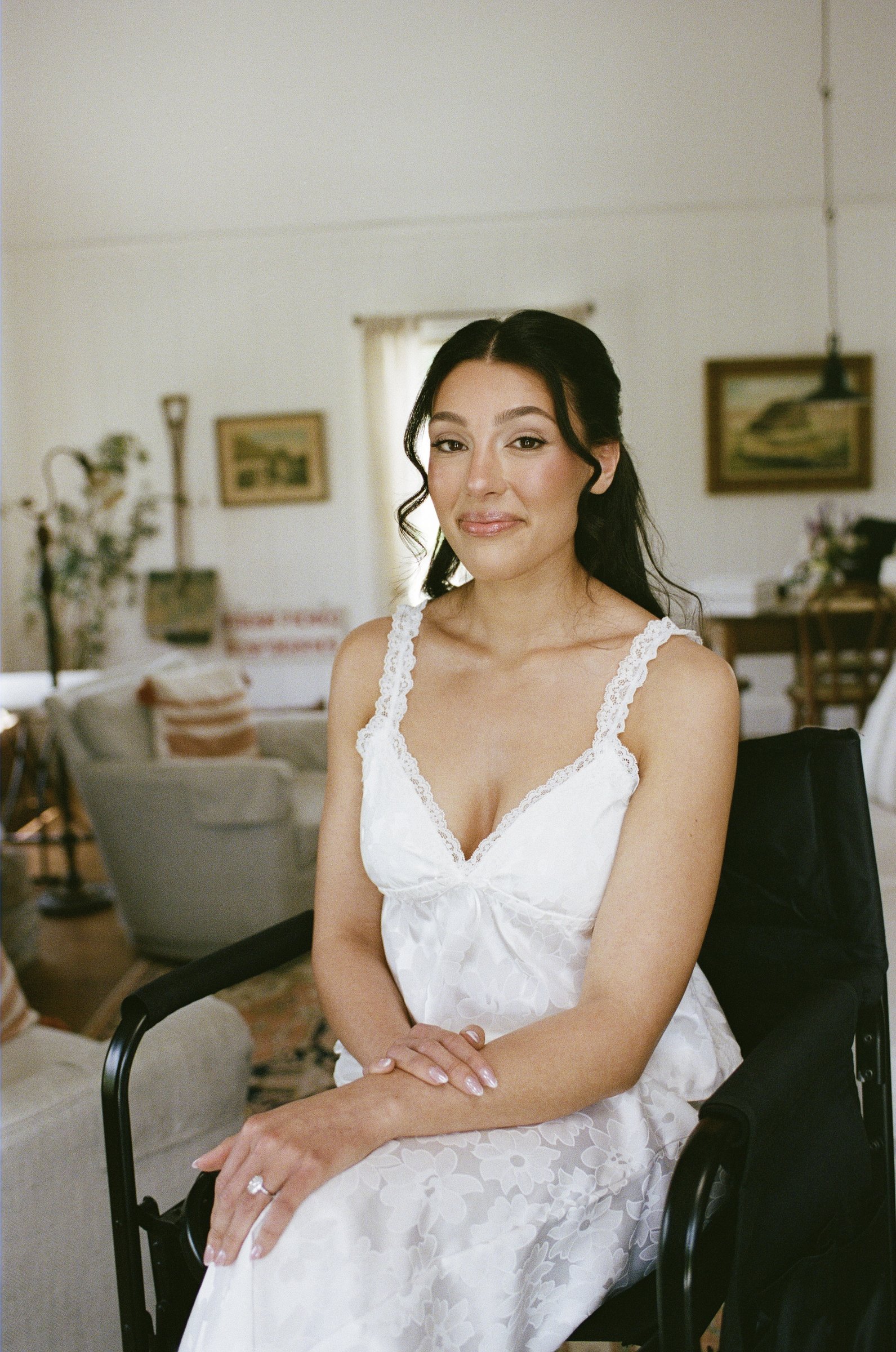 Kayla seated by the window in her lace gown