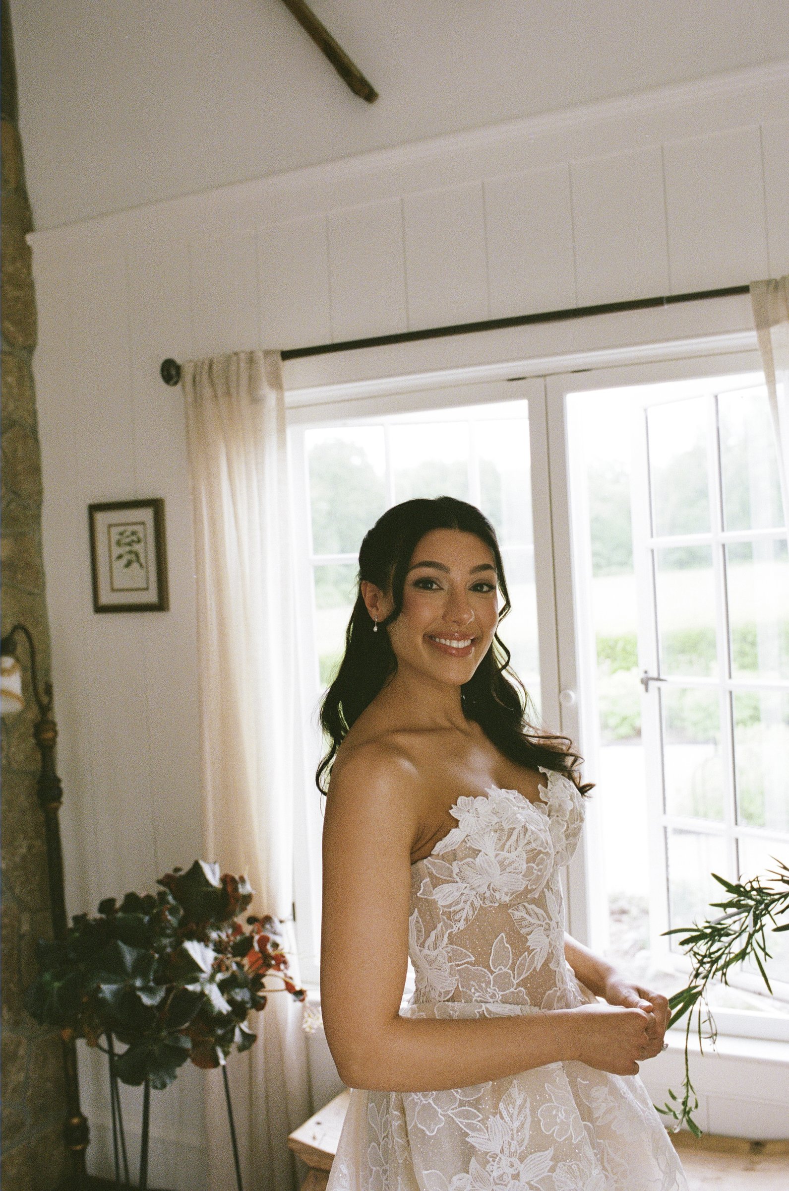 Kayla at the farmhouse window in her gown