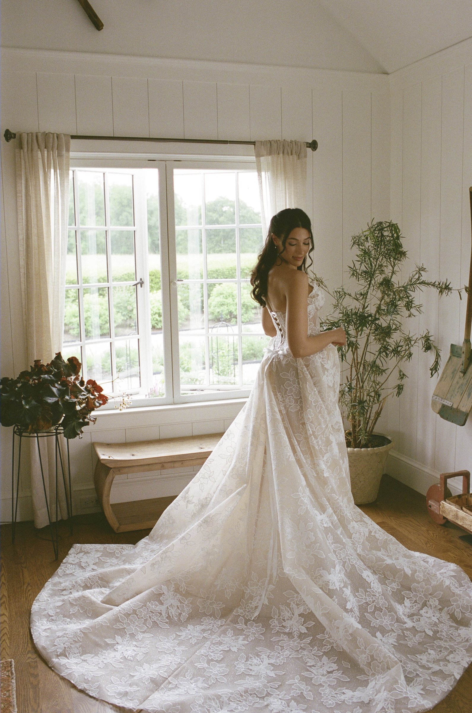 The train of Kayla's gown across the farmhouse floor