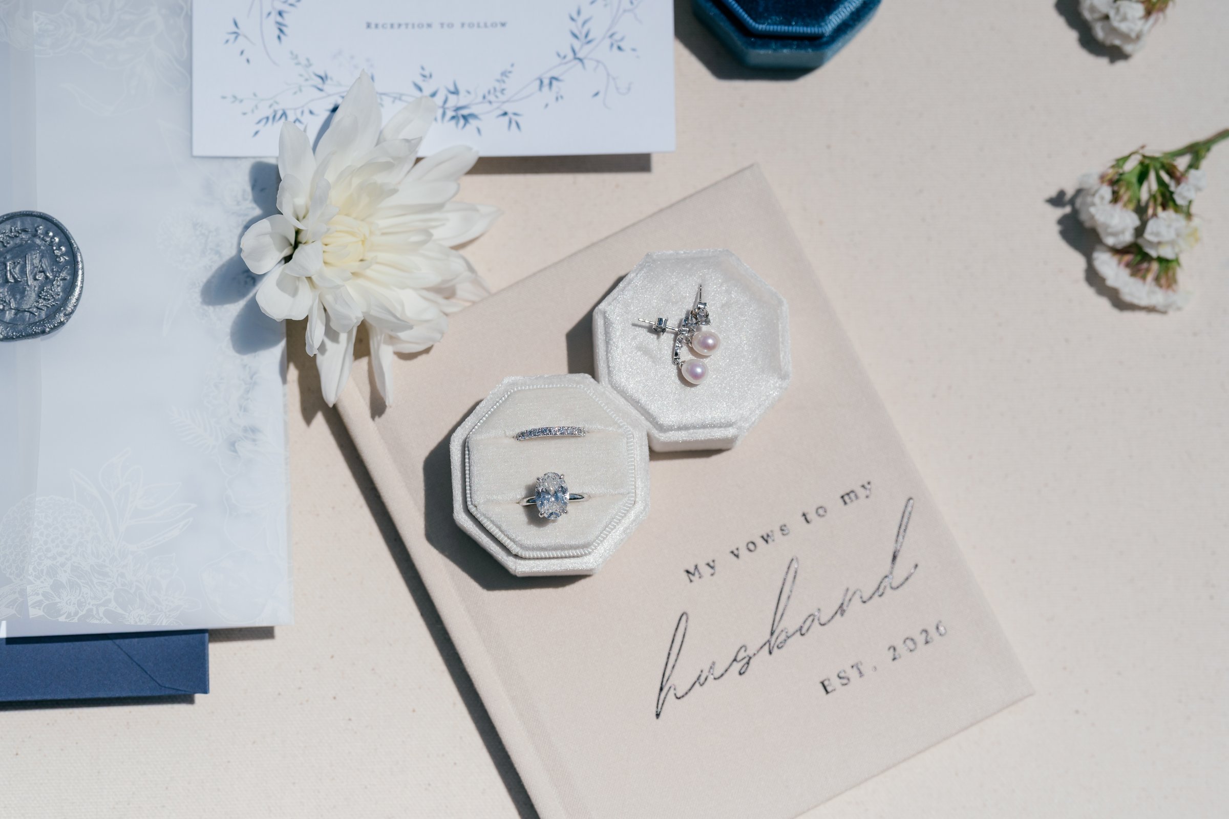 Ring boxes and Kayla's vow book, "My vows to my husband", on the invitation suite