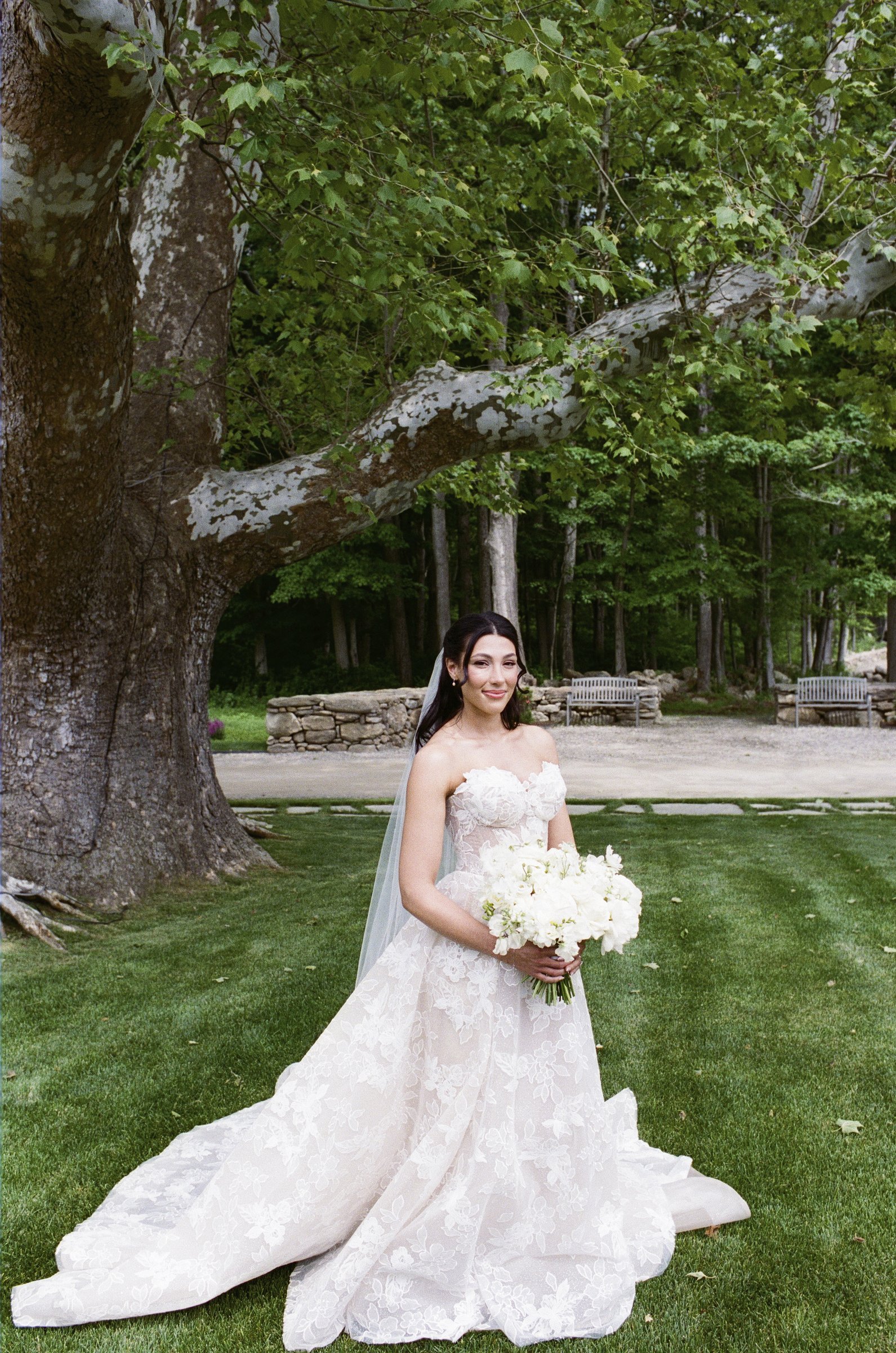 Kayla with her bouquet under the maple tree