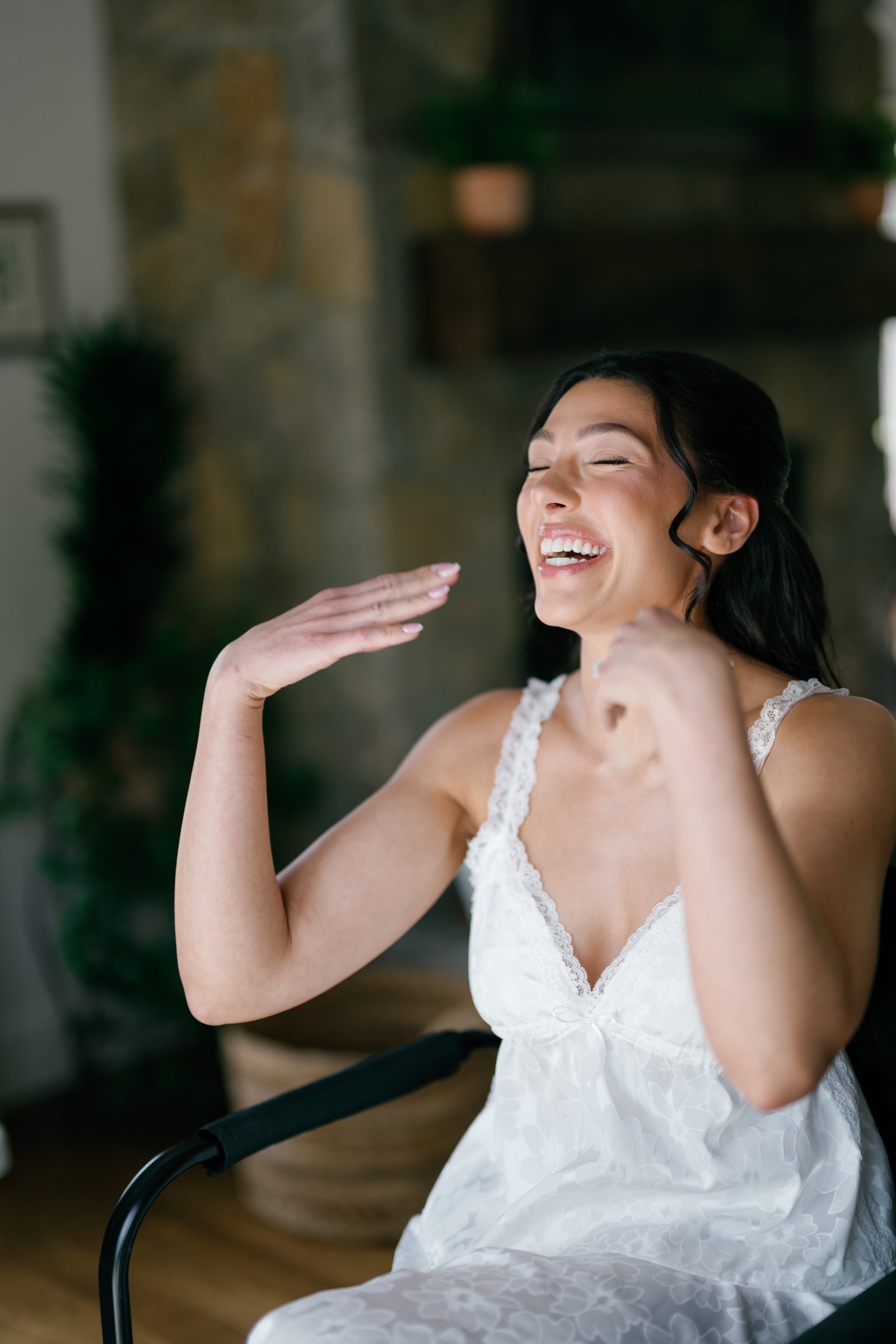 Kayla laughing during hair and makeup in the bridal cottage