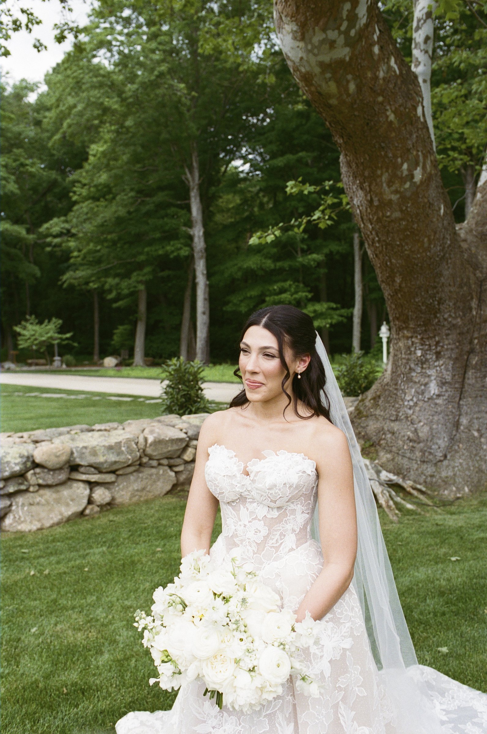 Kayla standing by the stone wall at Smith Farm Gardens