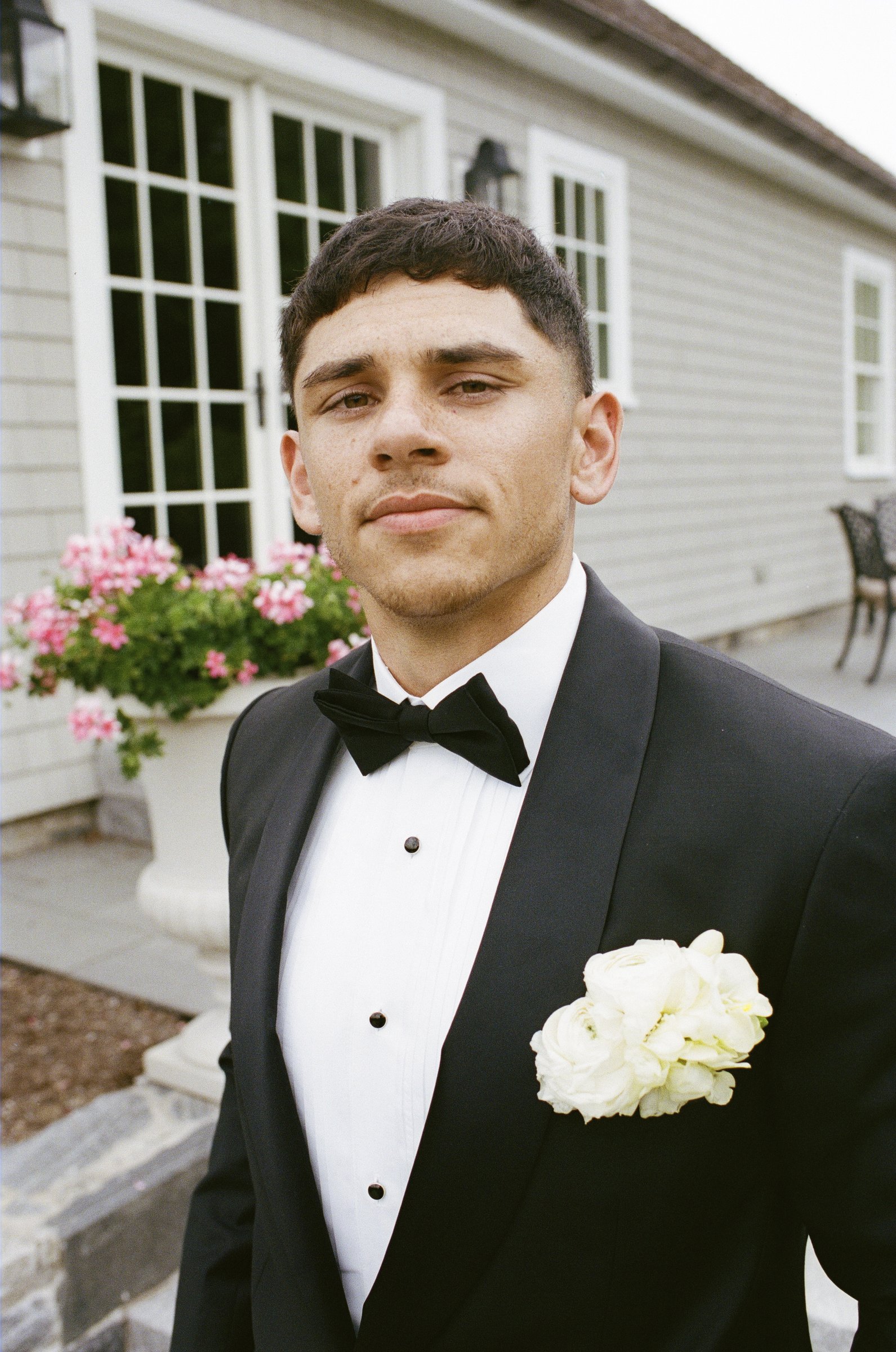 Avery in his black tuxedo with a white boutonniere