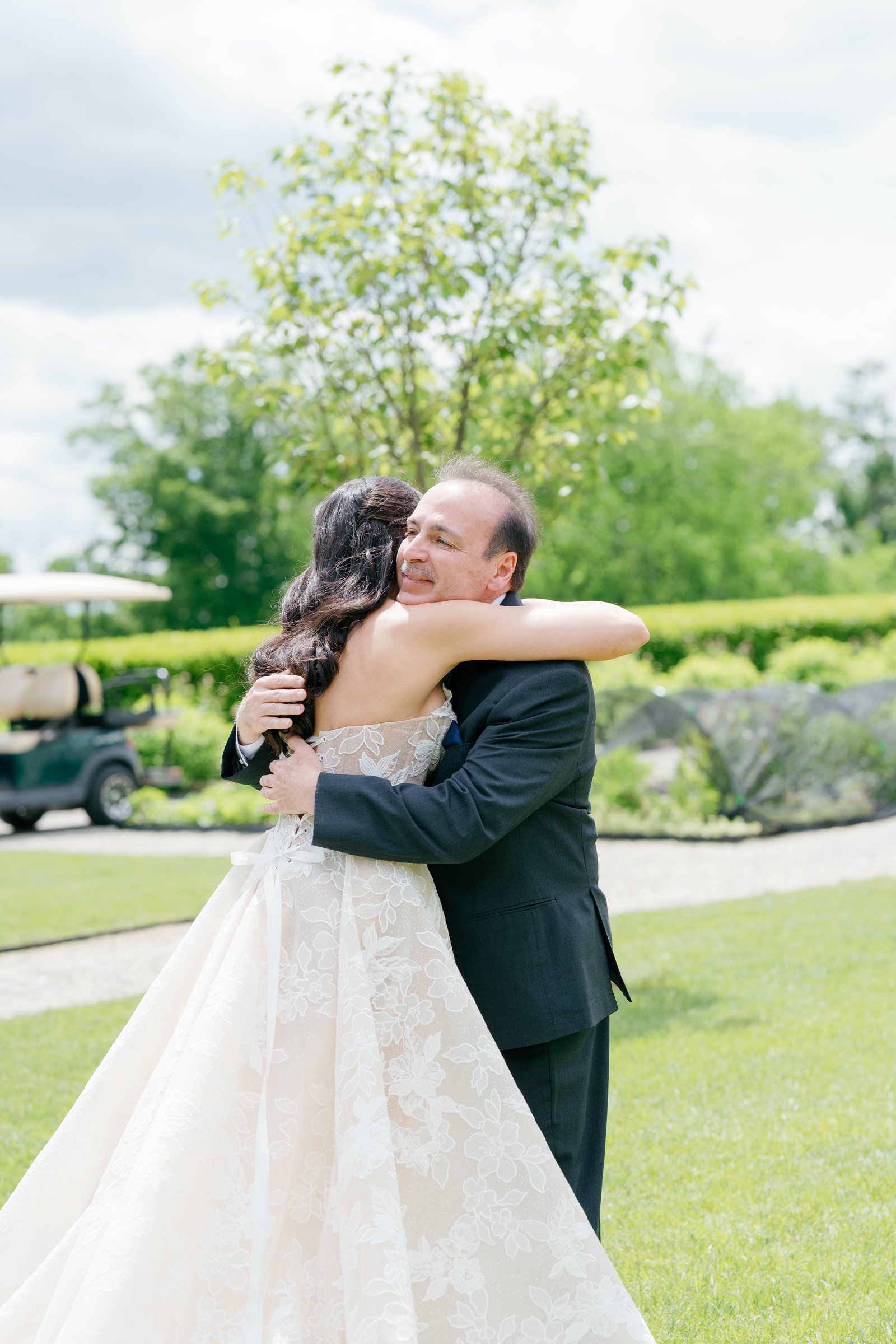 Kayla hugging her father on the lawn after his first look