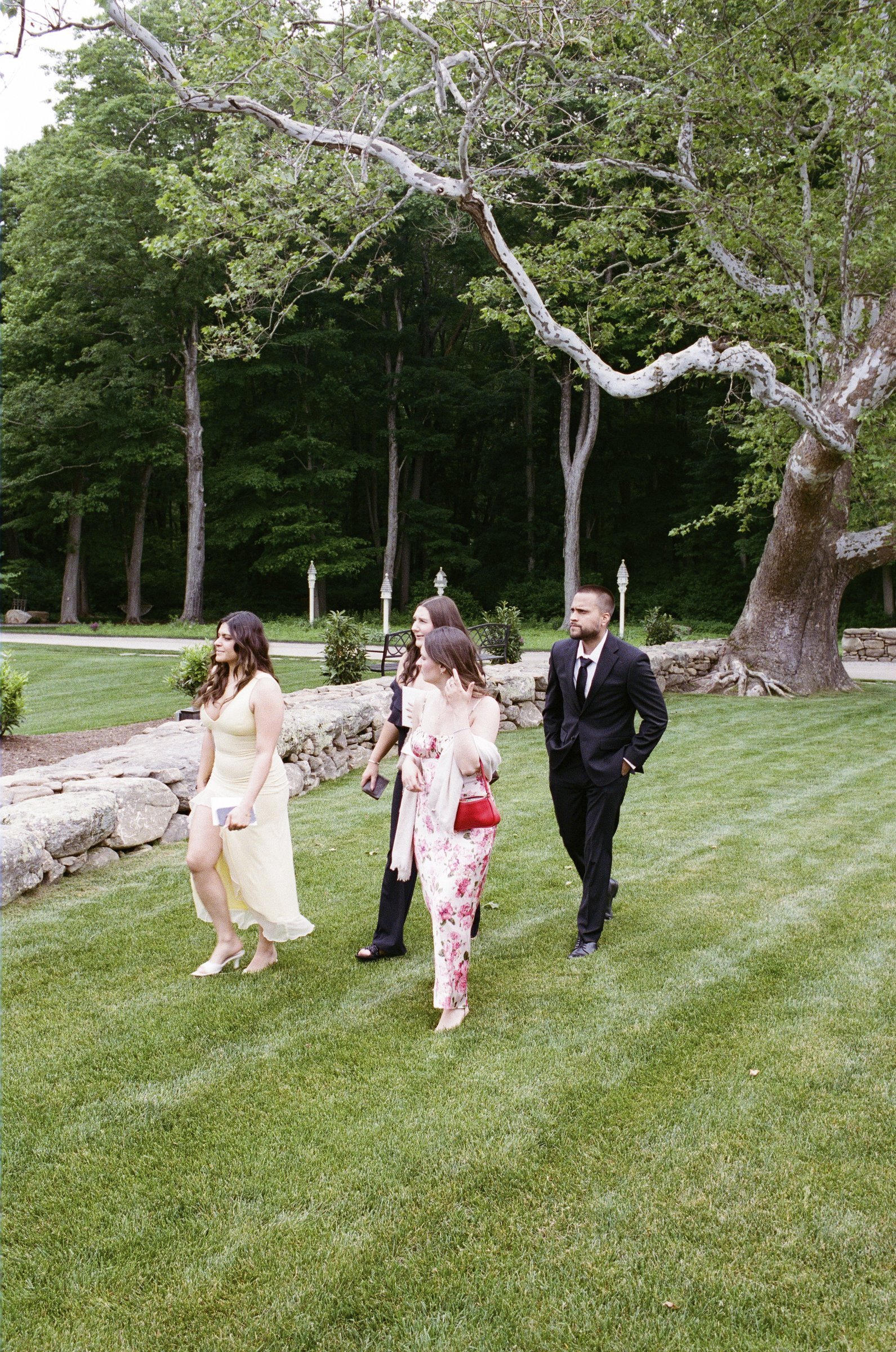 The bridal party walking across the lawn to the ceremony