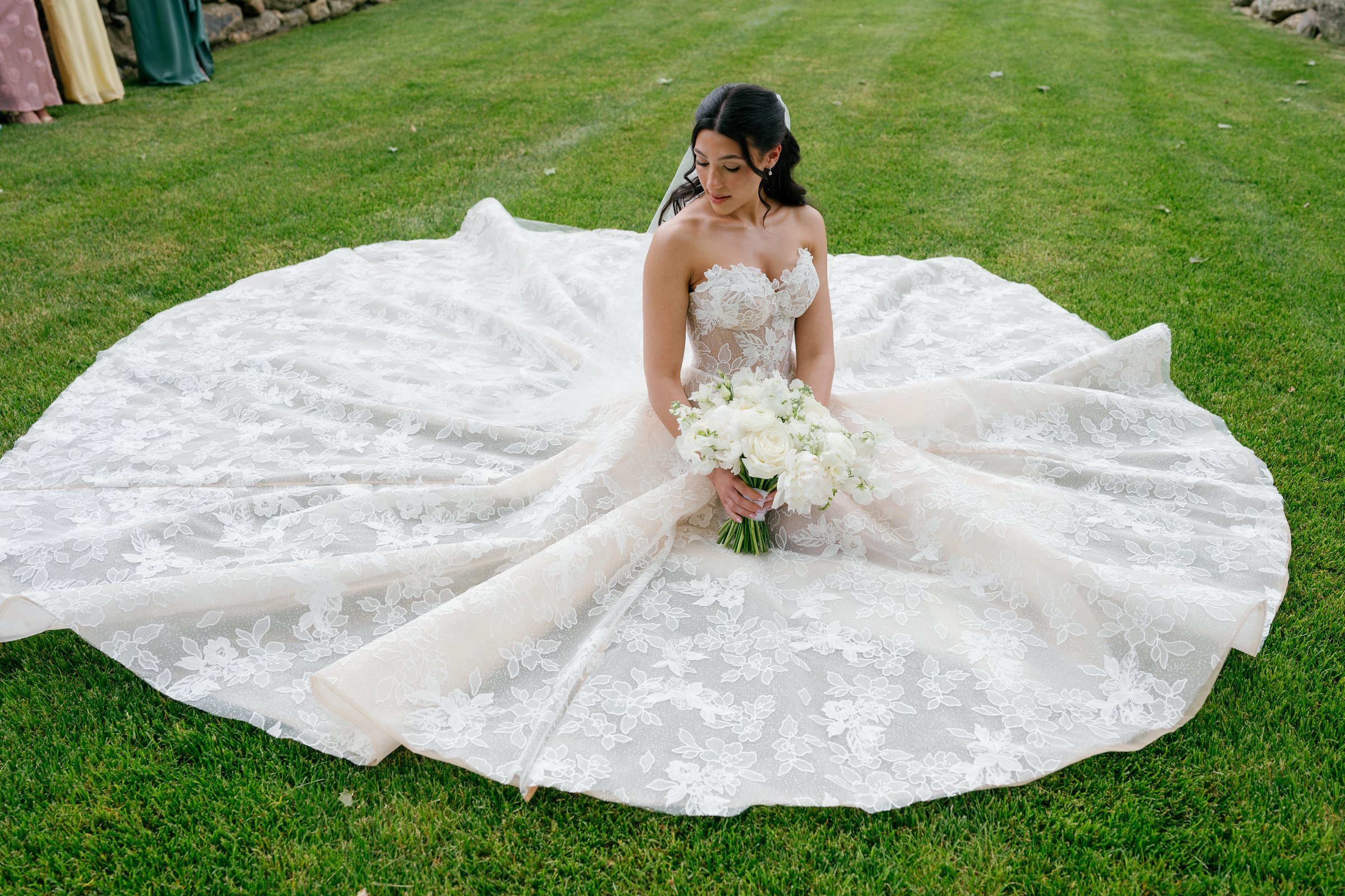 Kayla sitting on the lawn with her gown spread in a wide circle around her