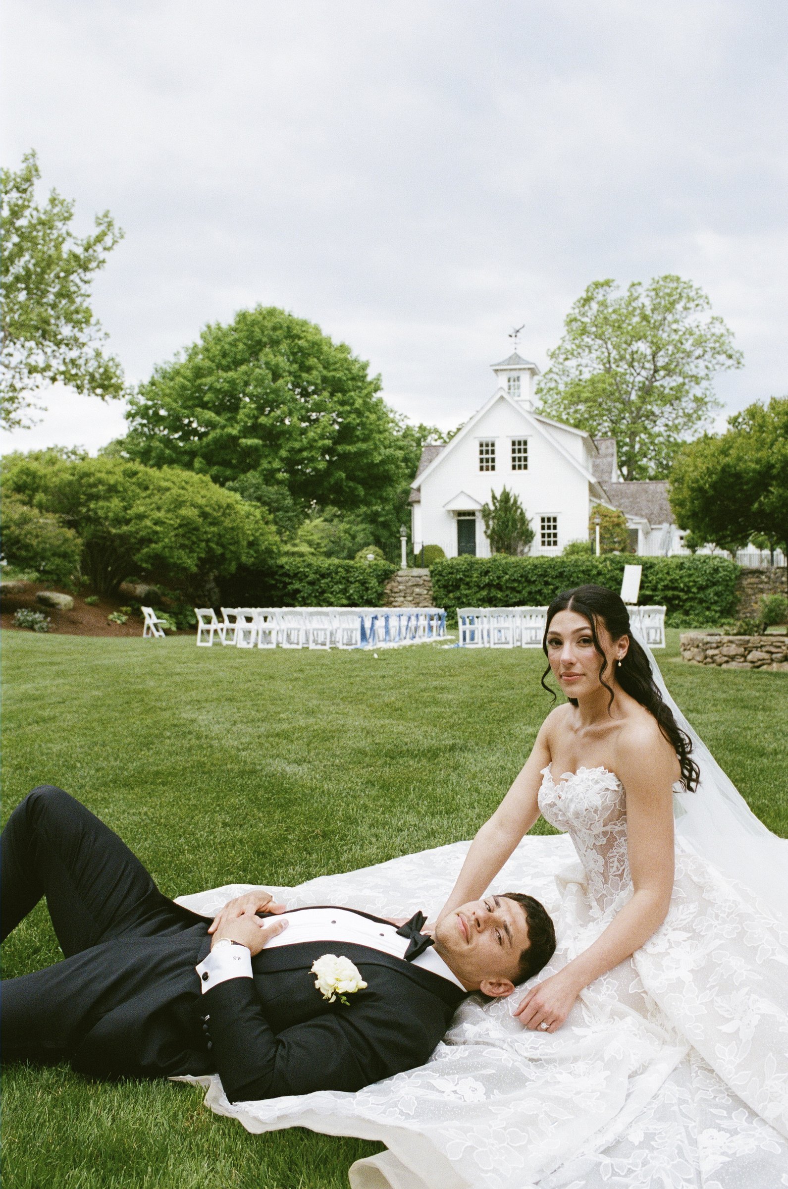 Kayla and Avery lying in the grass after the ceremony