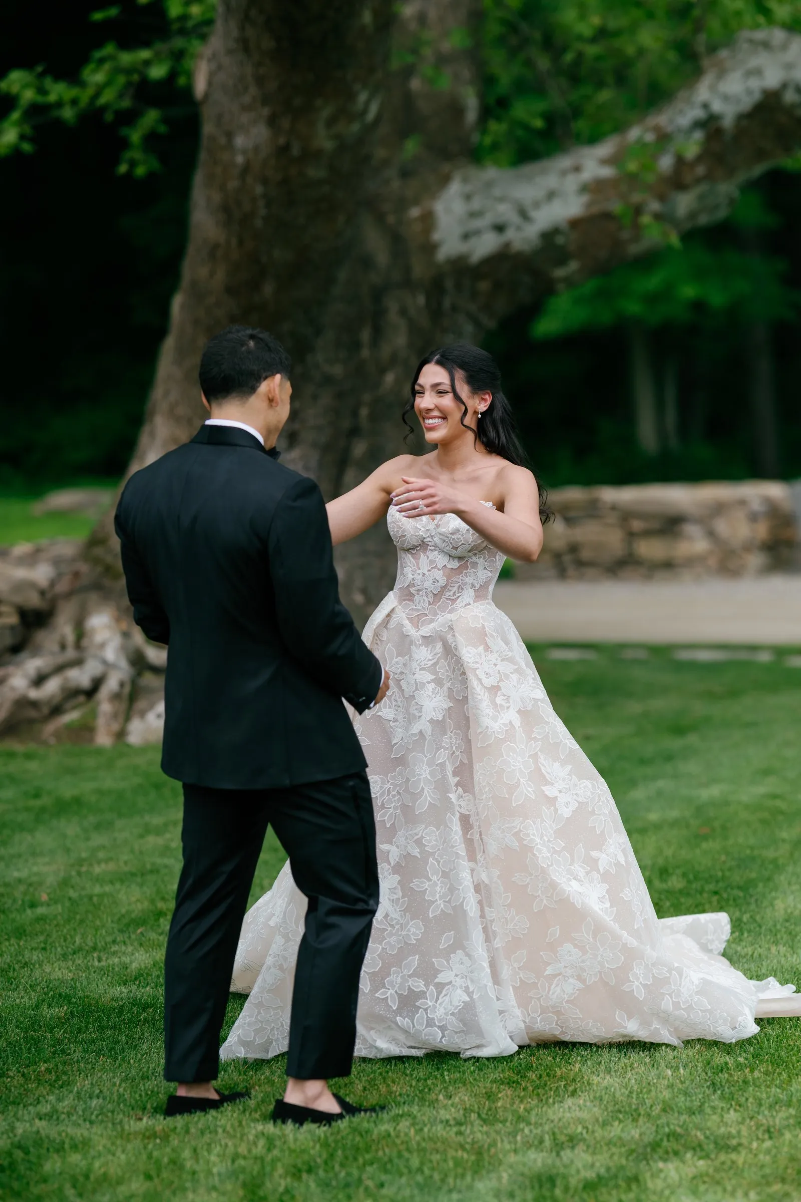 Avery turning to see Kayla at their first look under the sycamore