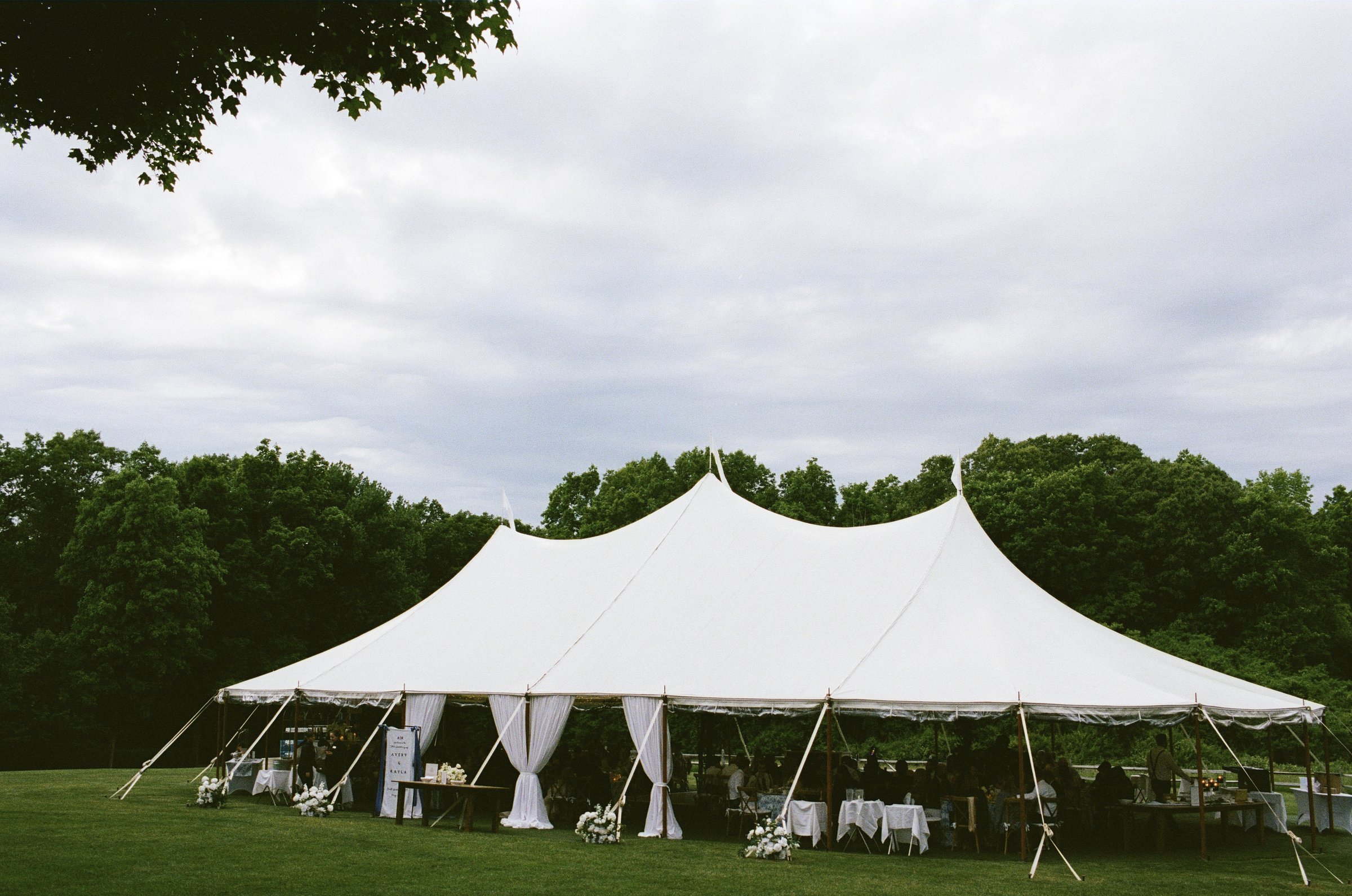 The white sailcloth tent in the meadow at Smith Farm Gardens