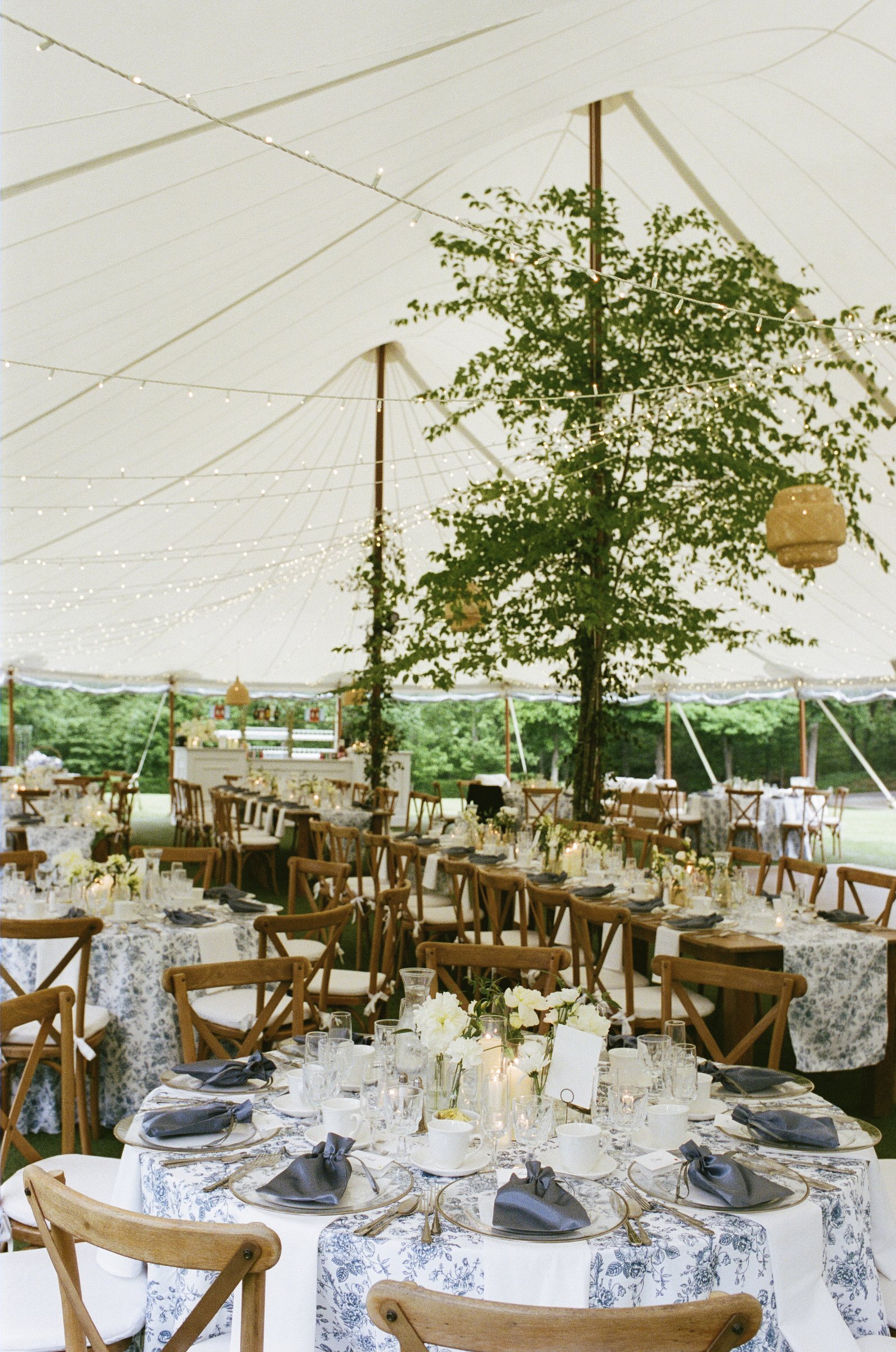 The tables set under the tent before dinner