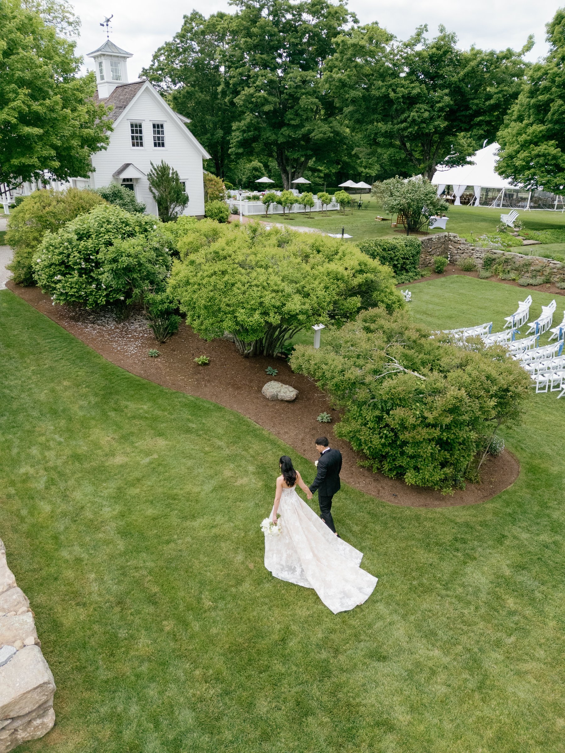 Kayla and Avery on the garden lawn below the white chapel, seen from above