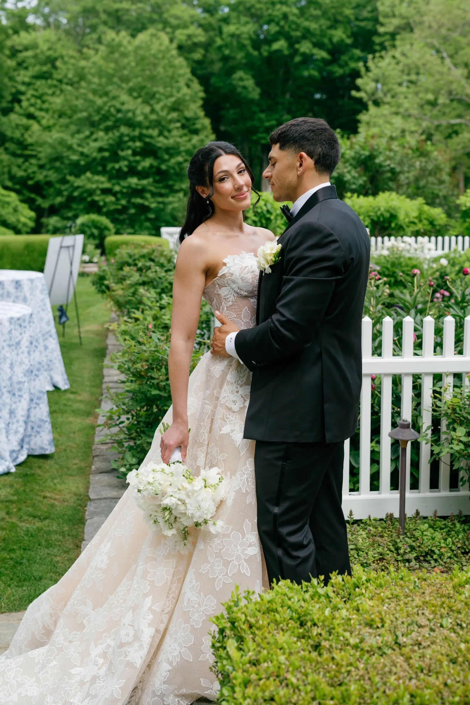 Kayla and Avery close together by the picket fence