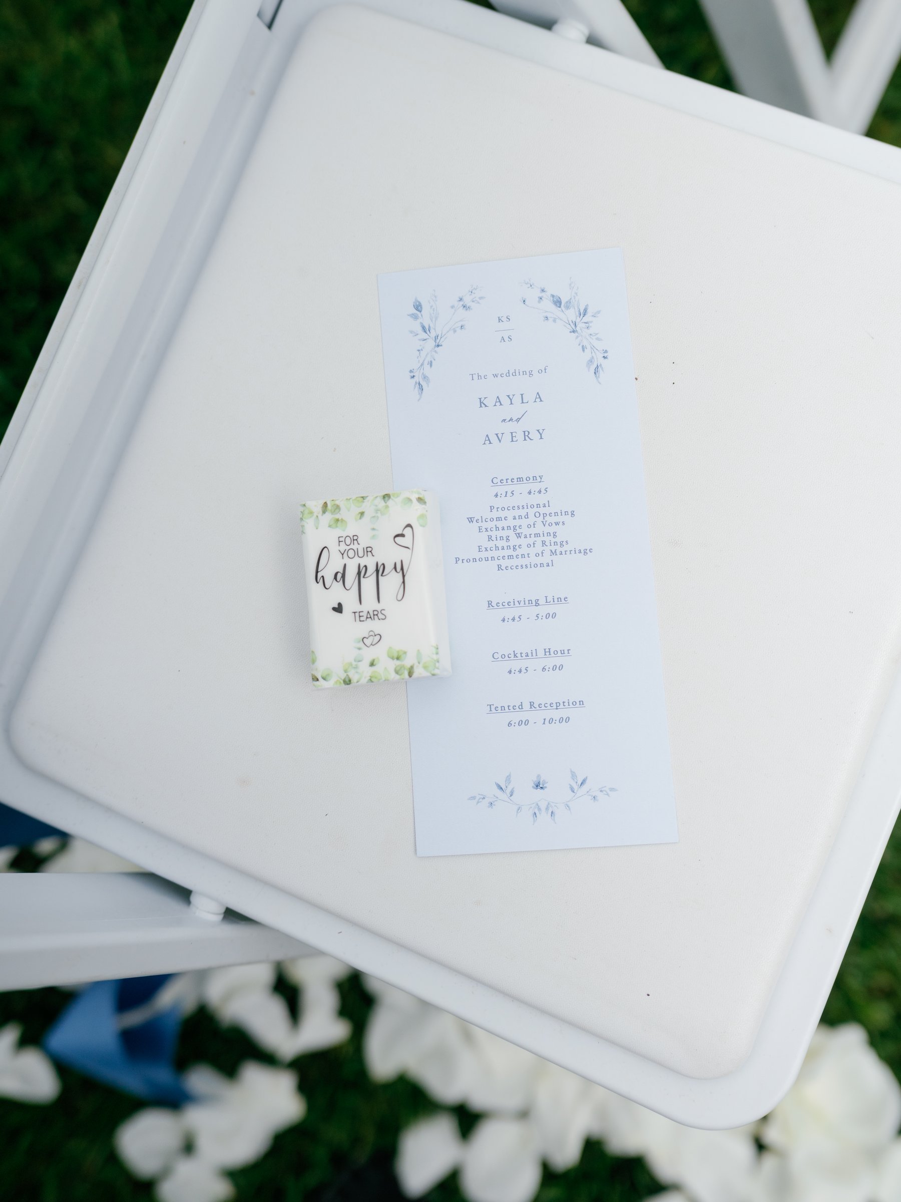 The ceremony program on a white chair