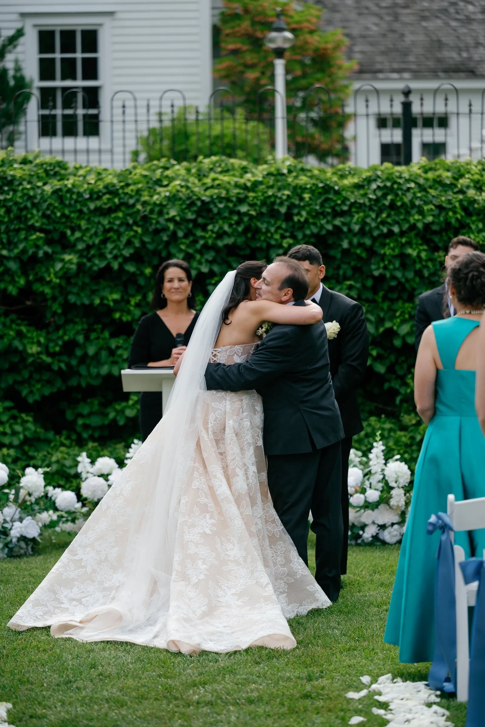 Kayla's father hugging Avery at the altar as he gives her away