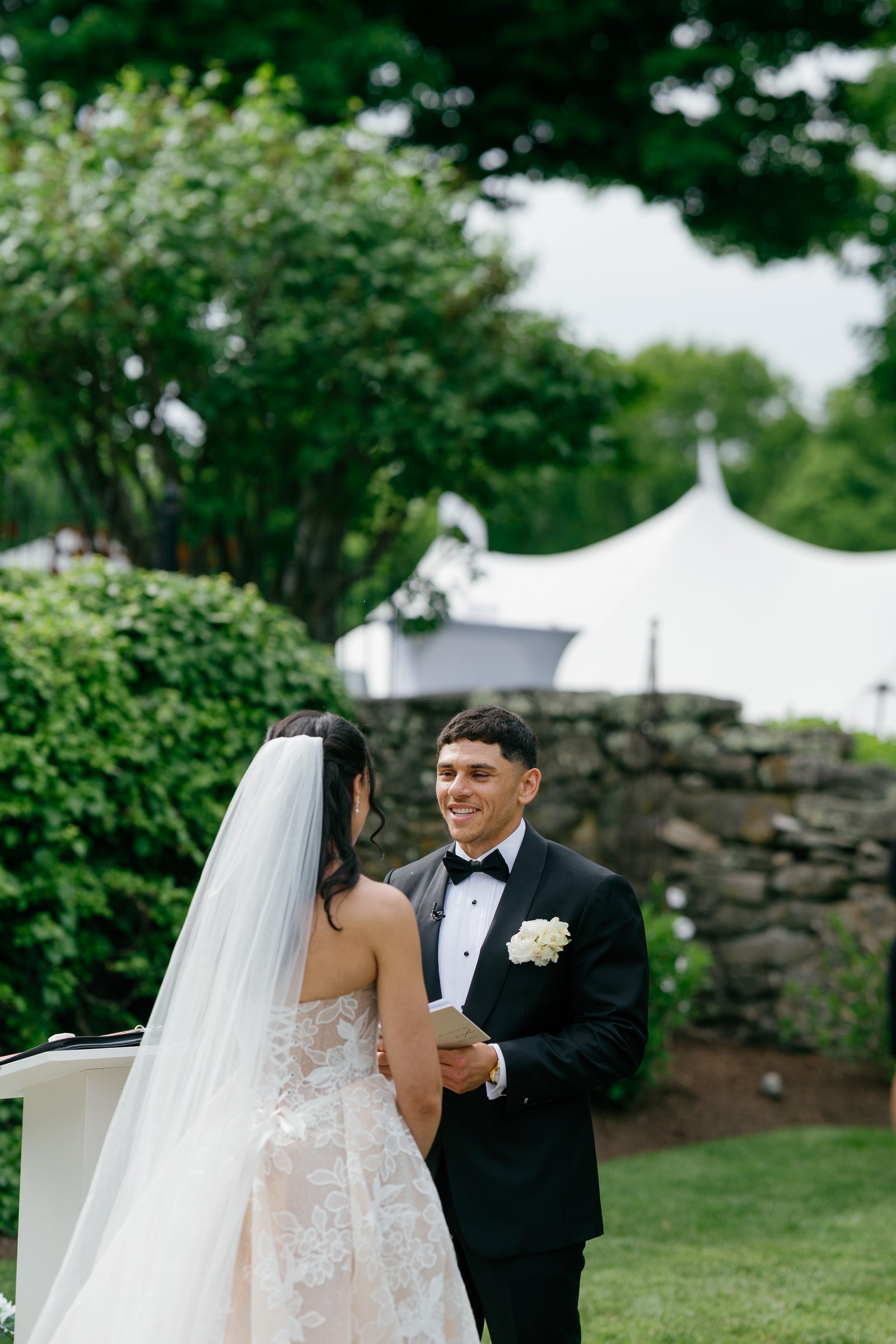 Avery smiling at Kayla as she reads her vows