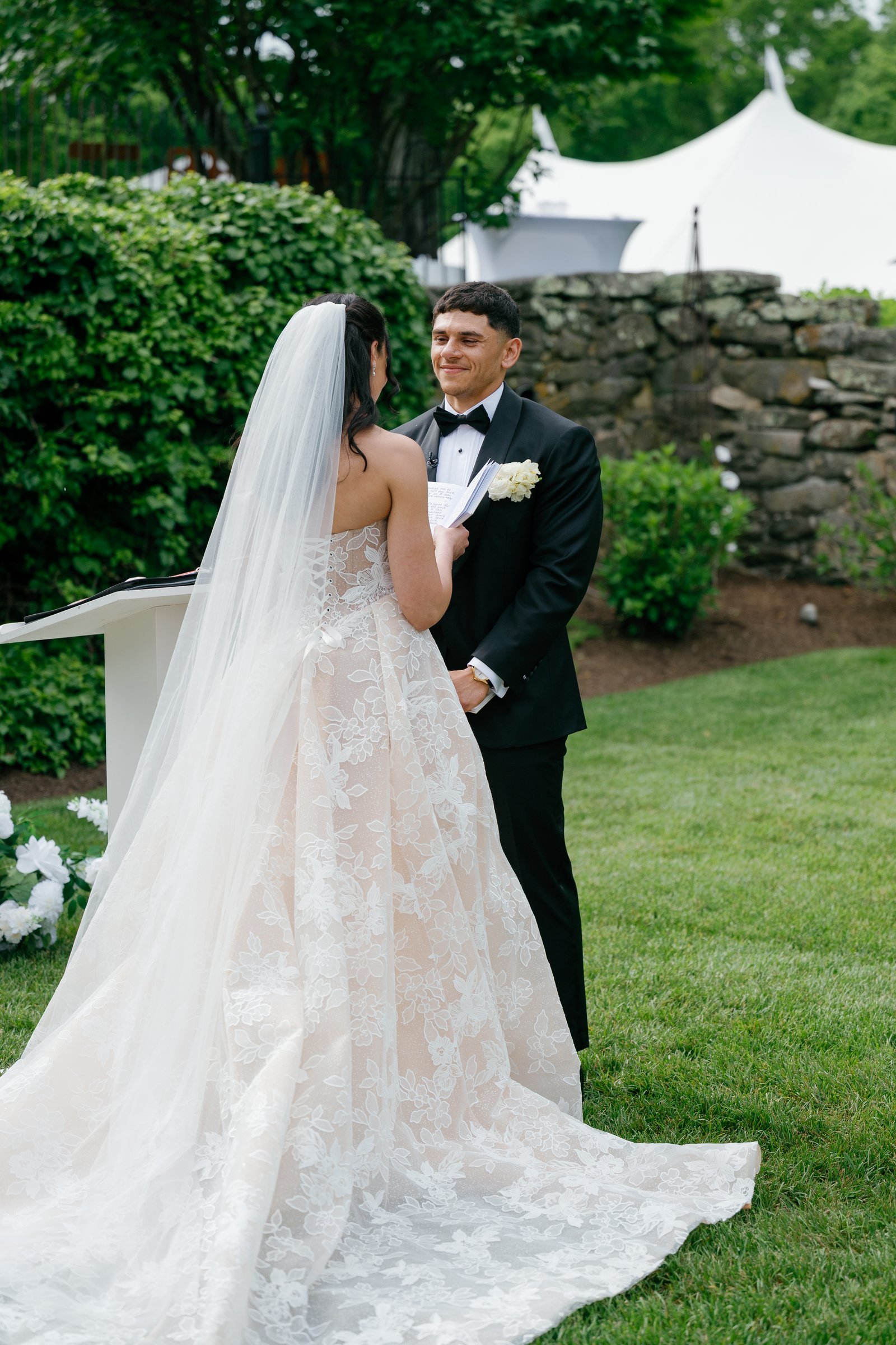 Kayla and Avery laughing at the altar, the tent behind the stone wall