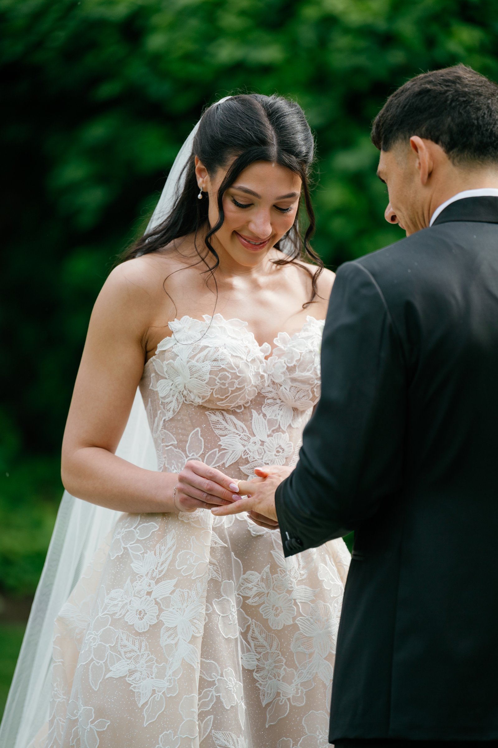 Kayla placing the ring on Avery's finger