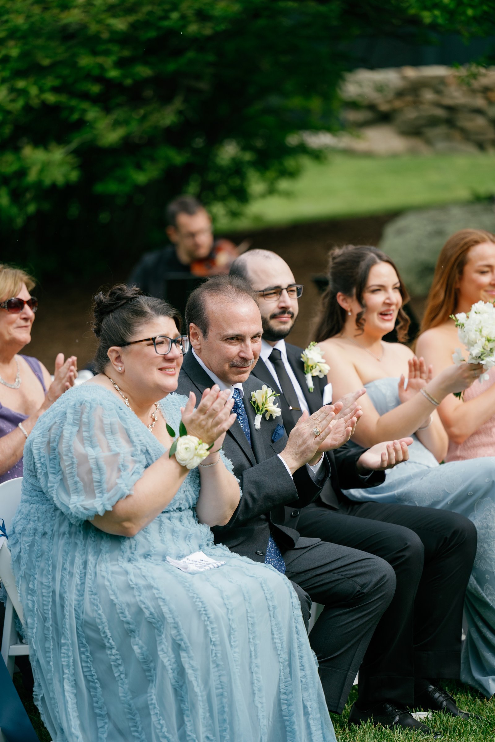 Kayla's mother and family clapping in the front row