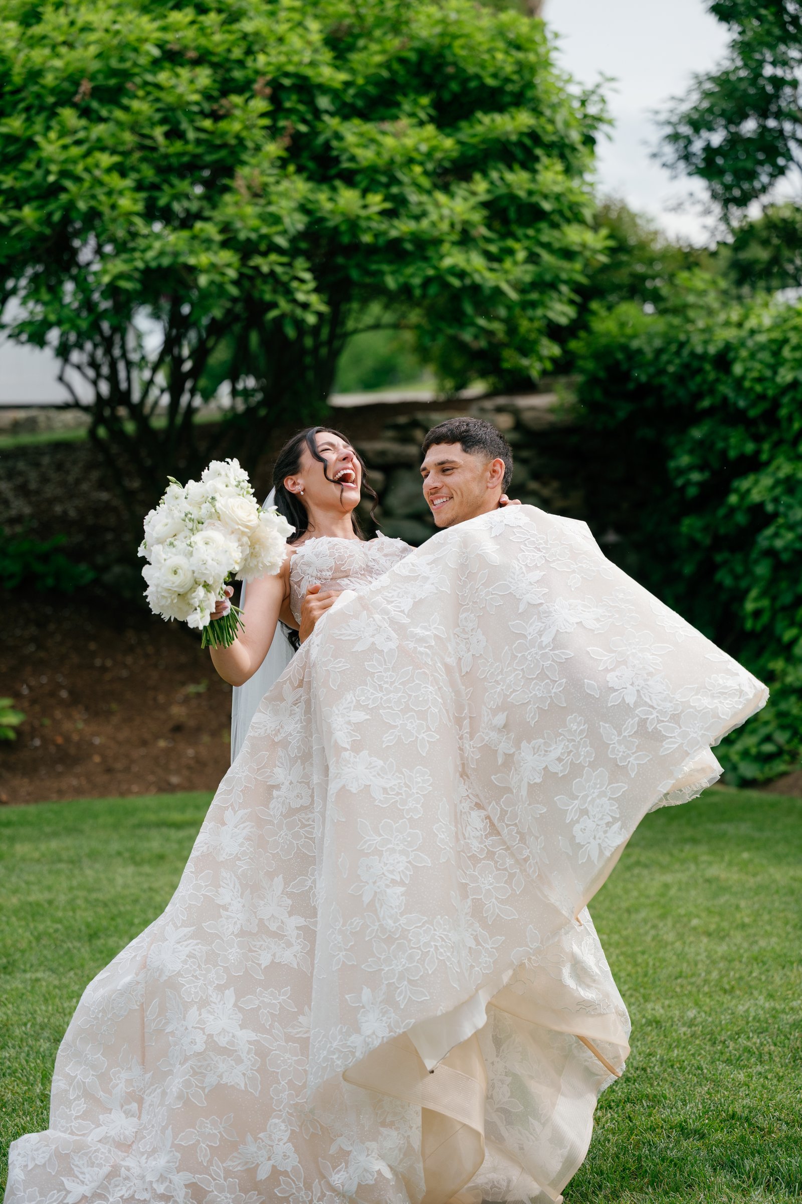 Avery lifting Kayla after the ceremony as she throws her head back laughing