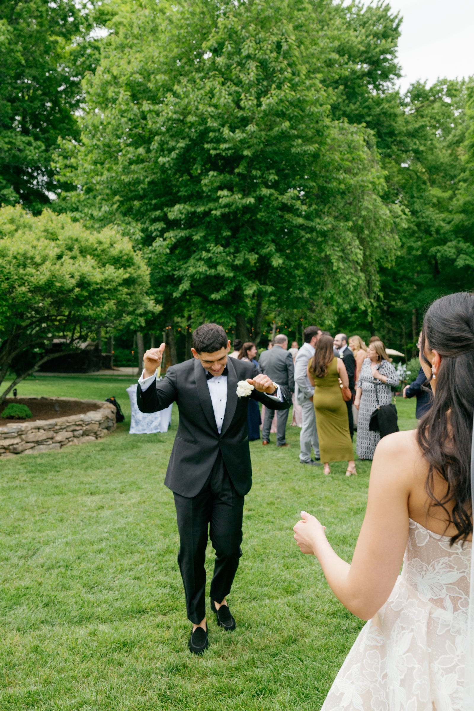 Avery dancing on the lawn as guests come over to greet them