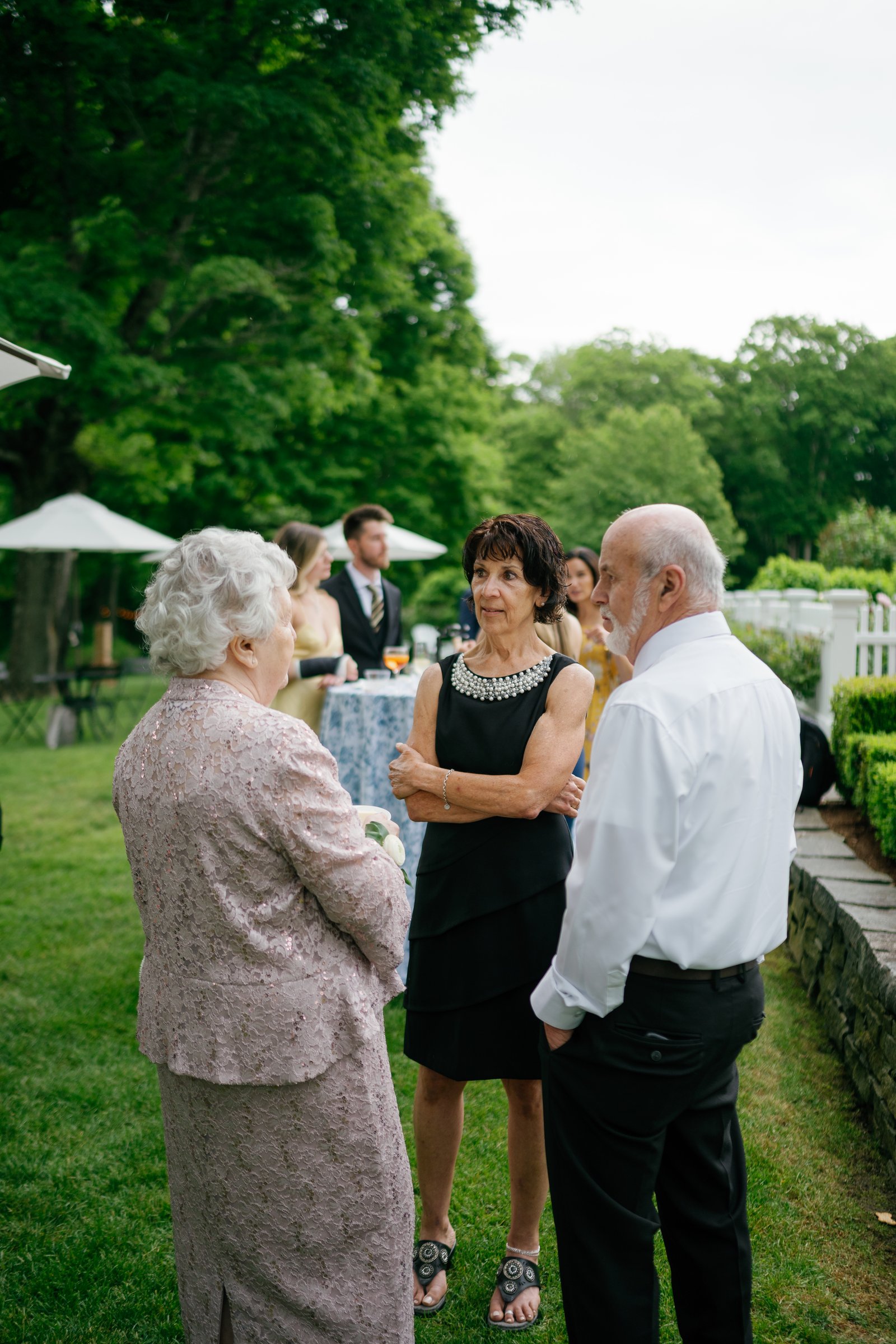 Kayla's grandmother talking with family on the lawn