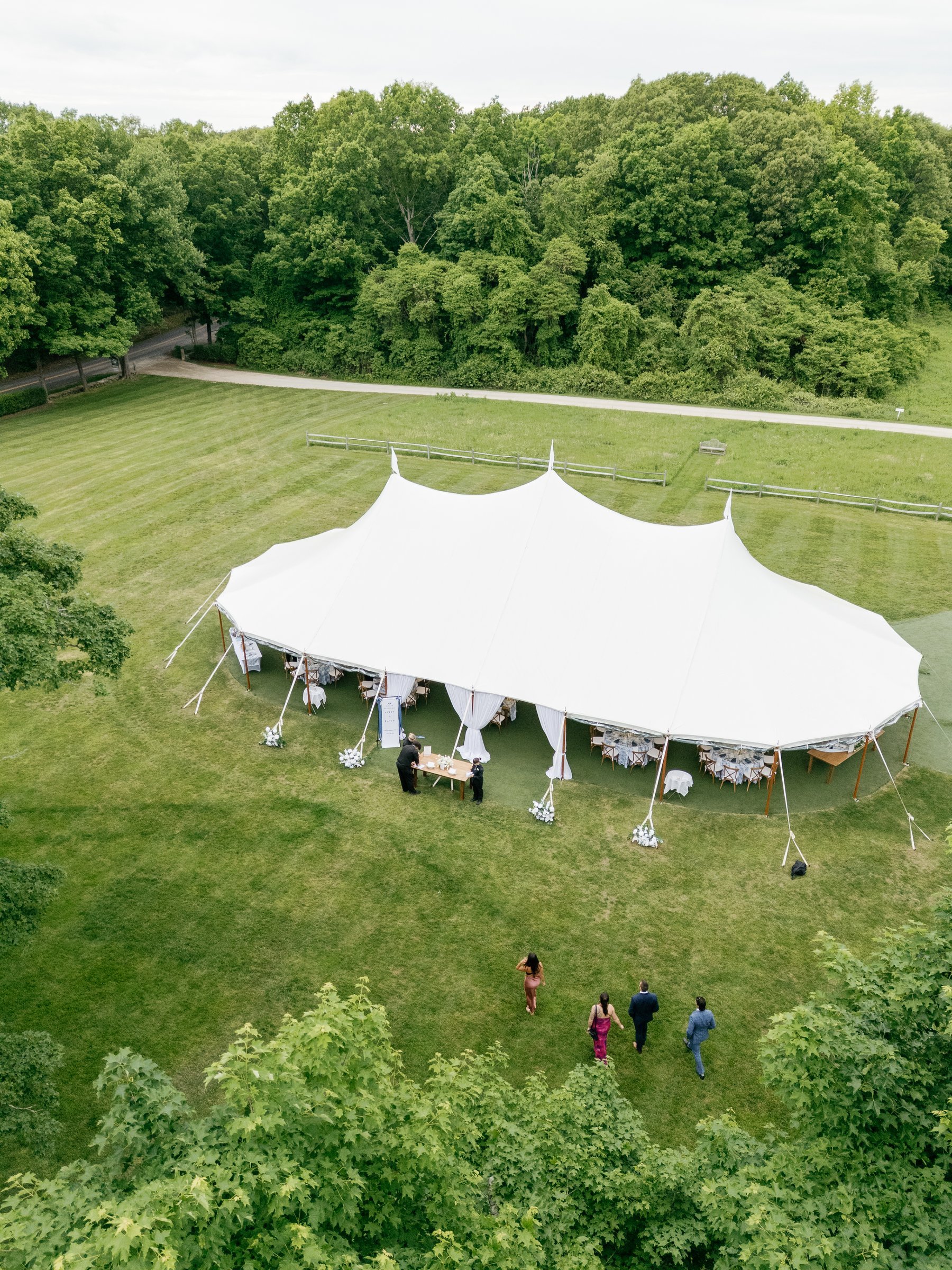 The white sailcloth tent in the meadow, seen from above