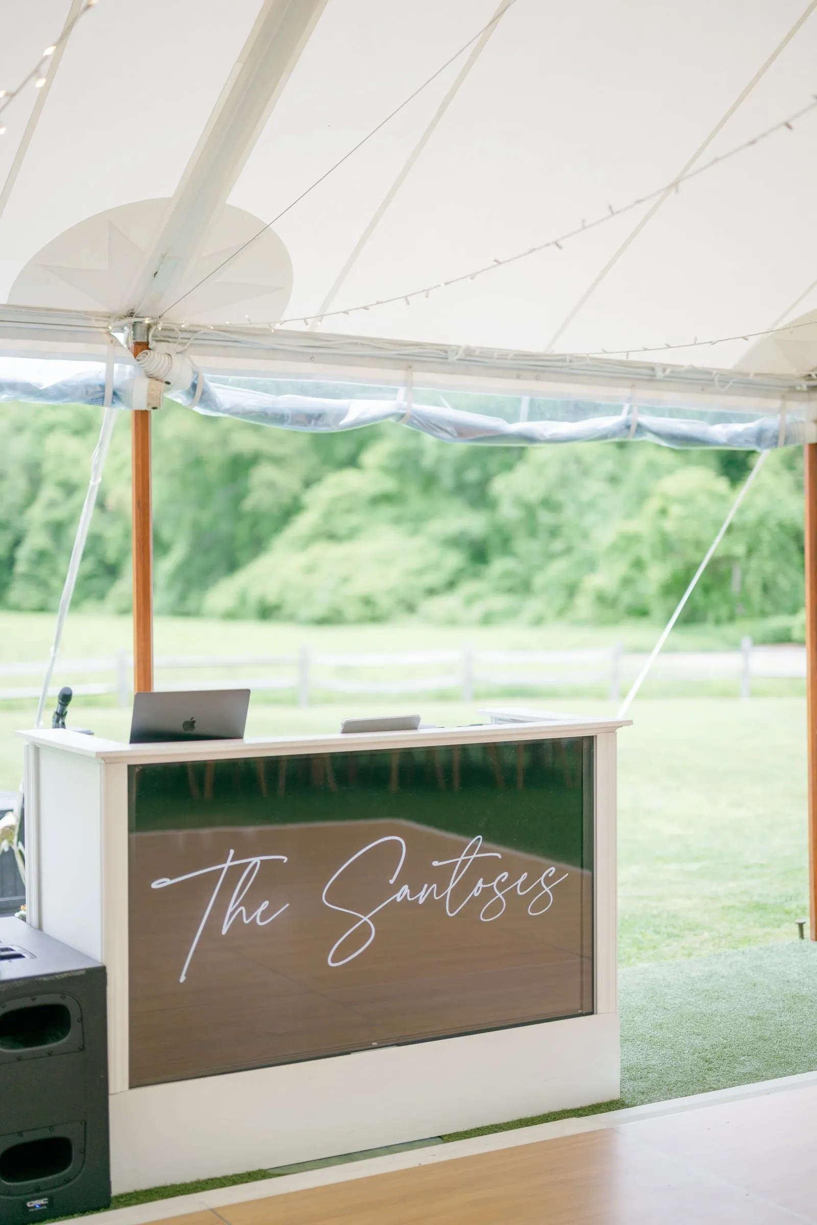 The DJ booth with "The Santoses" in neon script