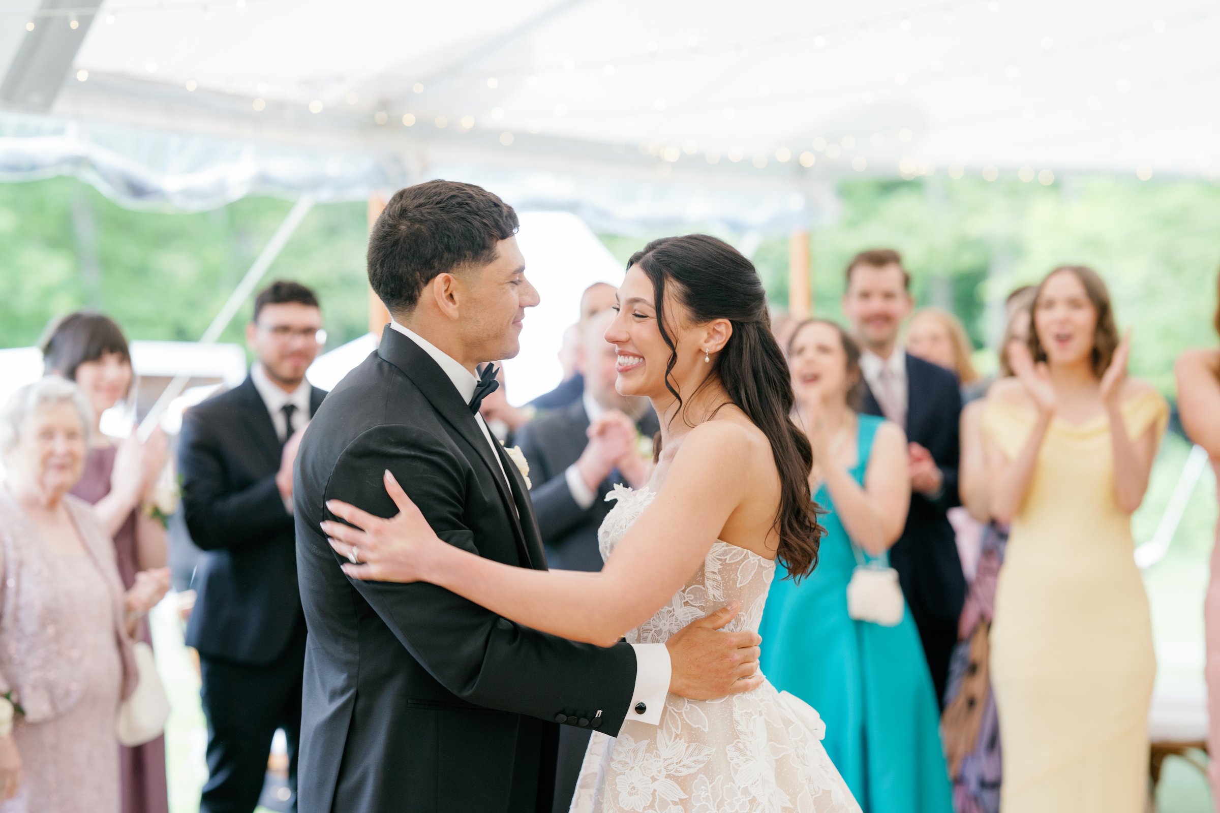 Kayla and Avery embracing as guests cheer their entrance
