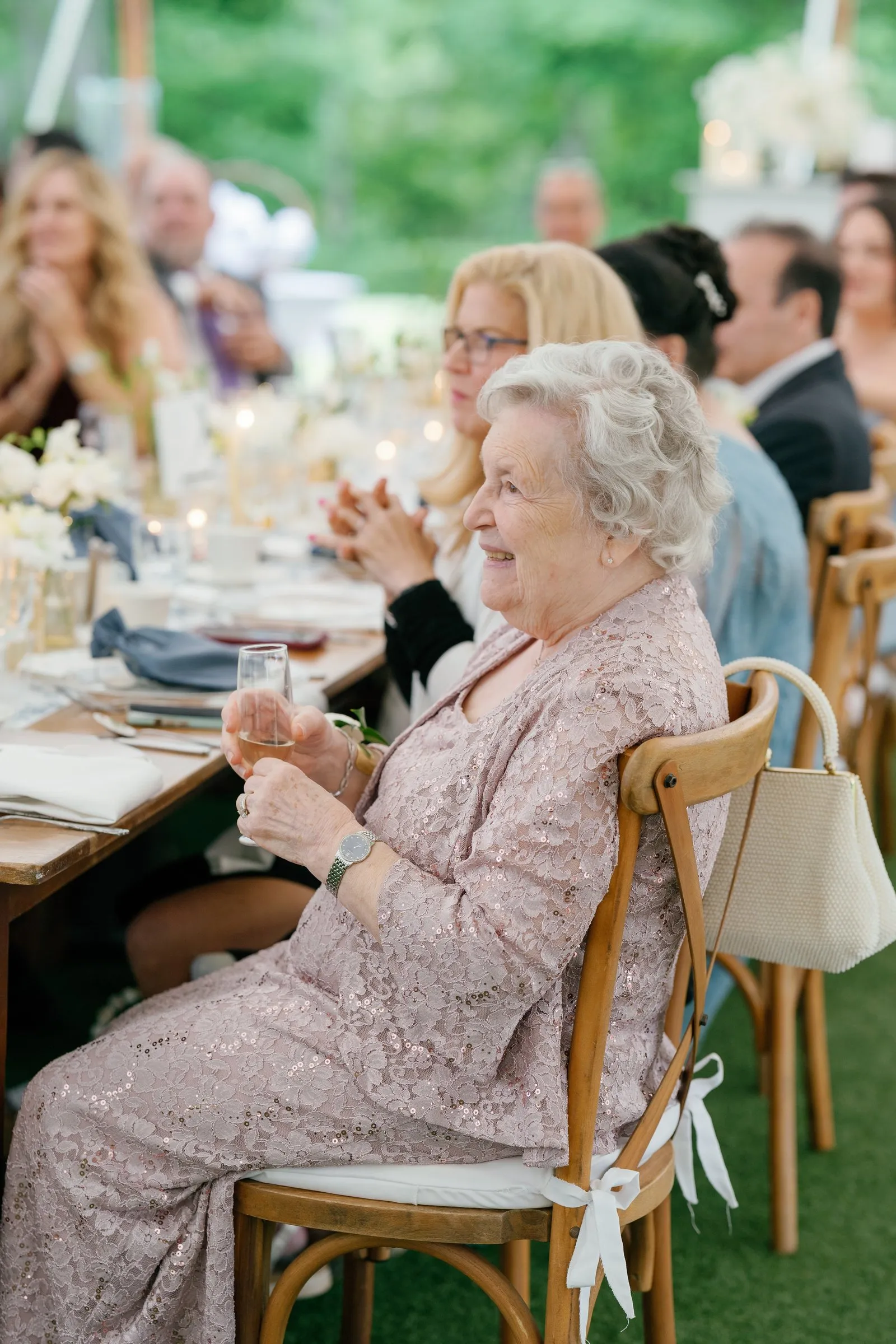 Kayla's grandmother smiling during the toasts