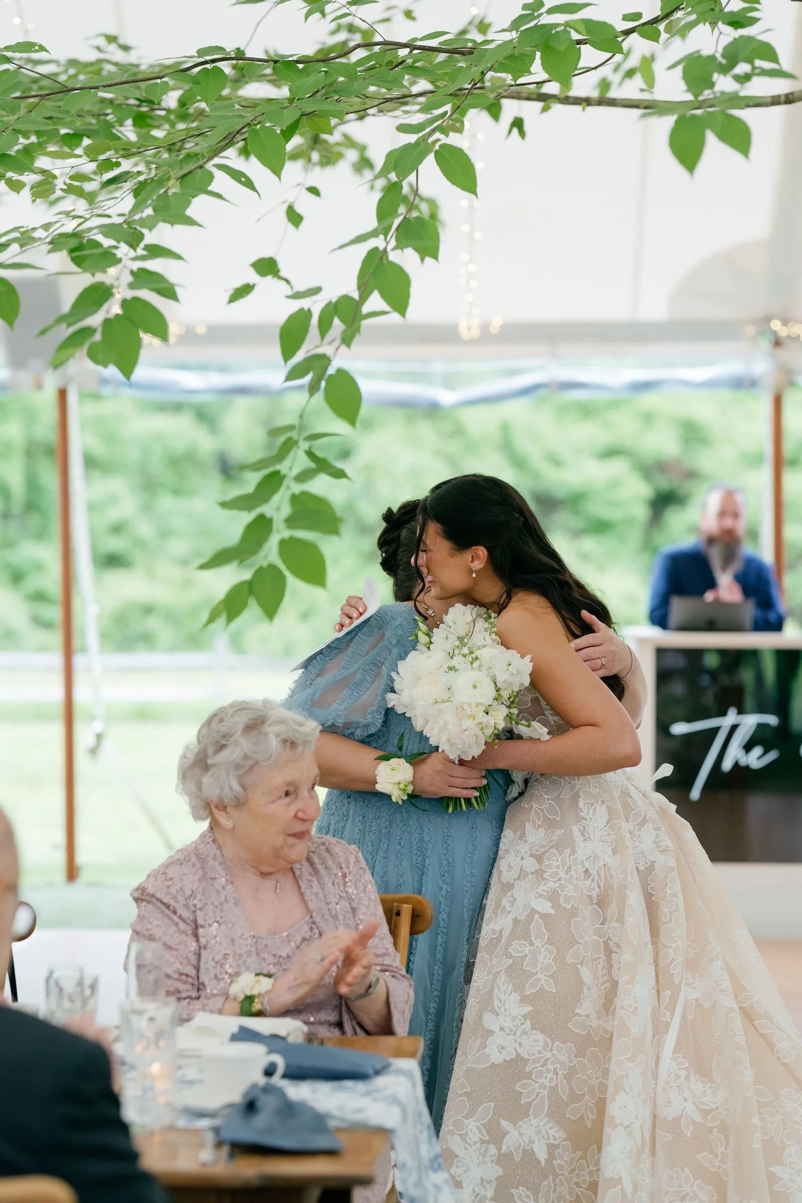 Kayla hugging her grandmother at her table