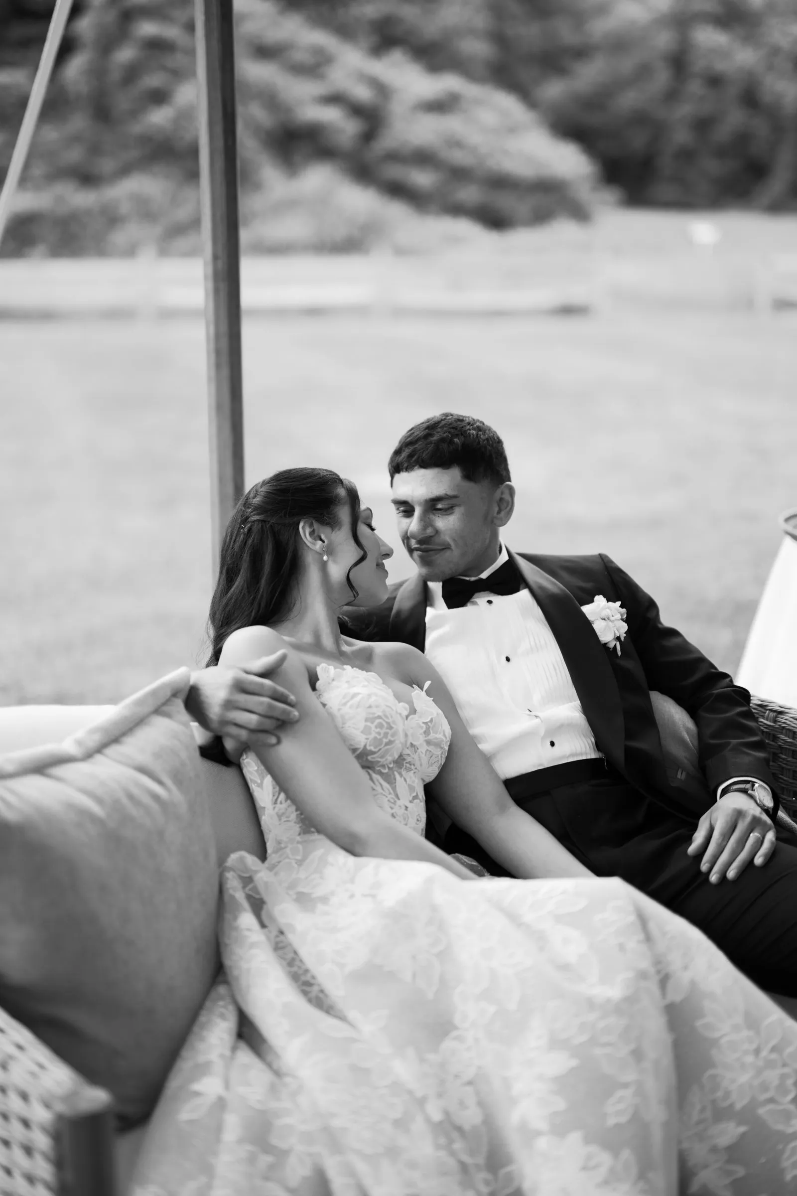 Kayla and Avery close together on the sofa, in black and white