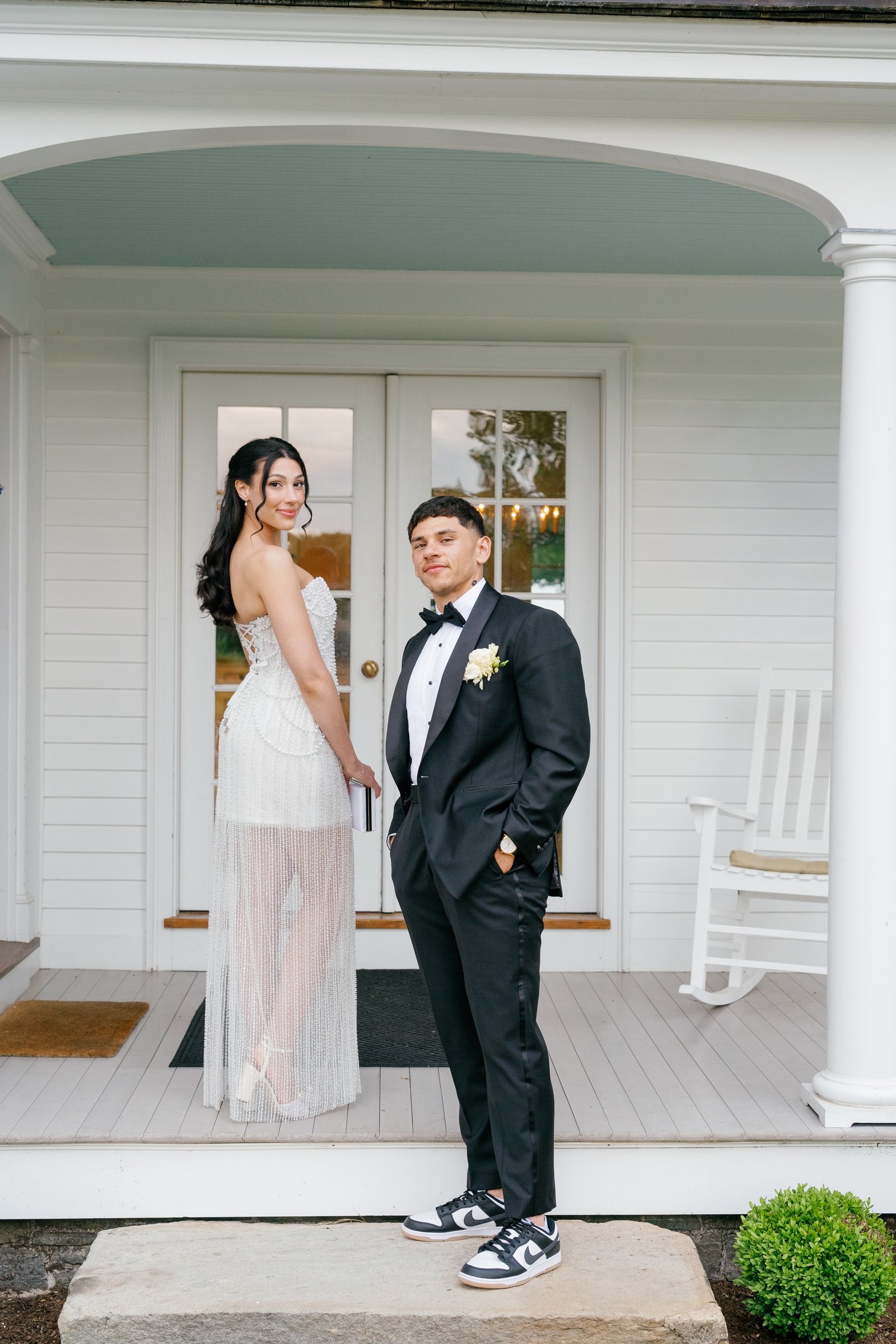 Kayla and Avery on the porch of the white house, Kayla in her second dress