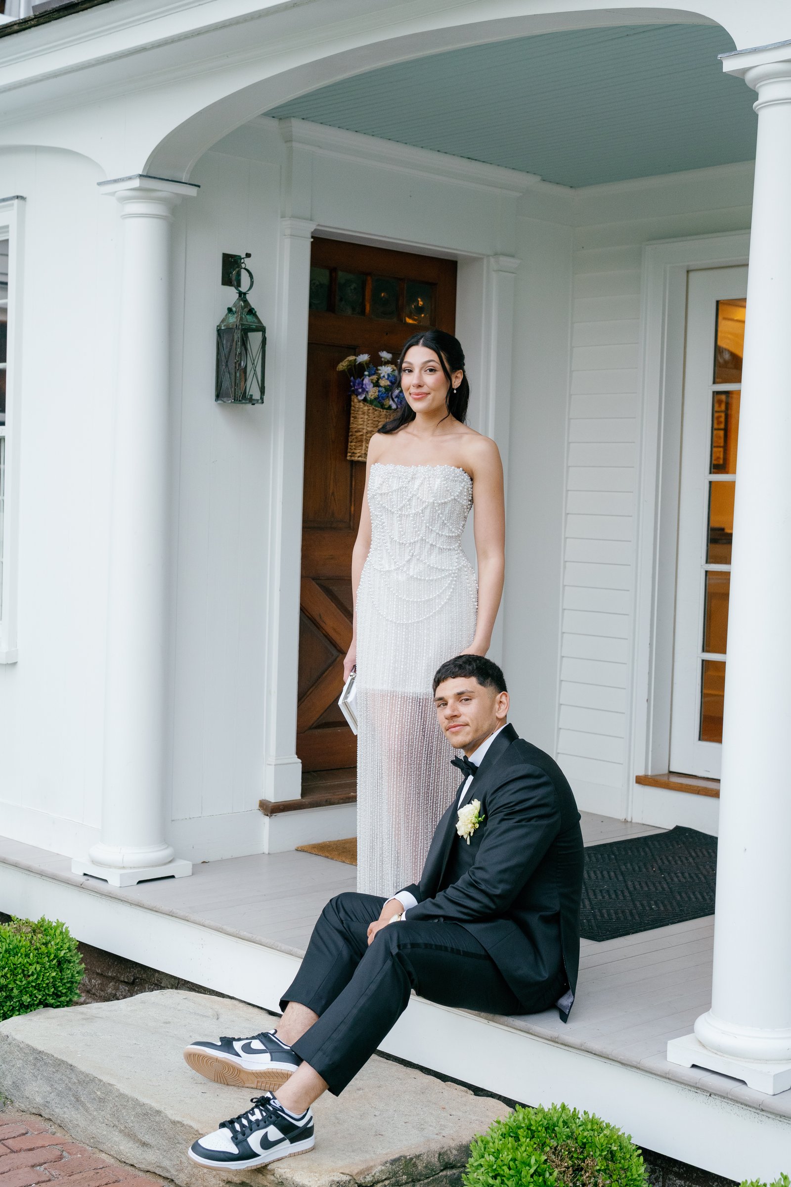 Kayla standing in the doorway as Avery sits on the porch step in sneakers