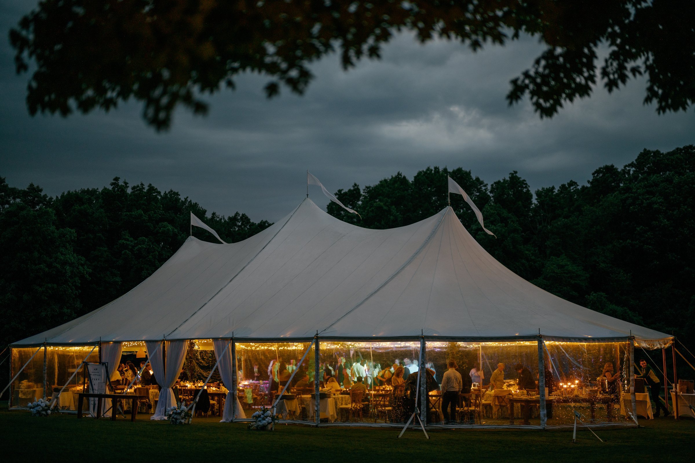 The sailcloth tent glowing at dusk under a dark sky