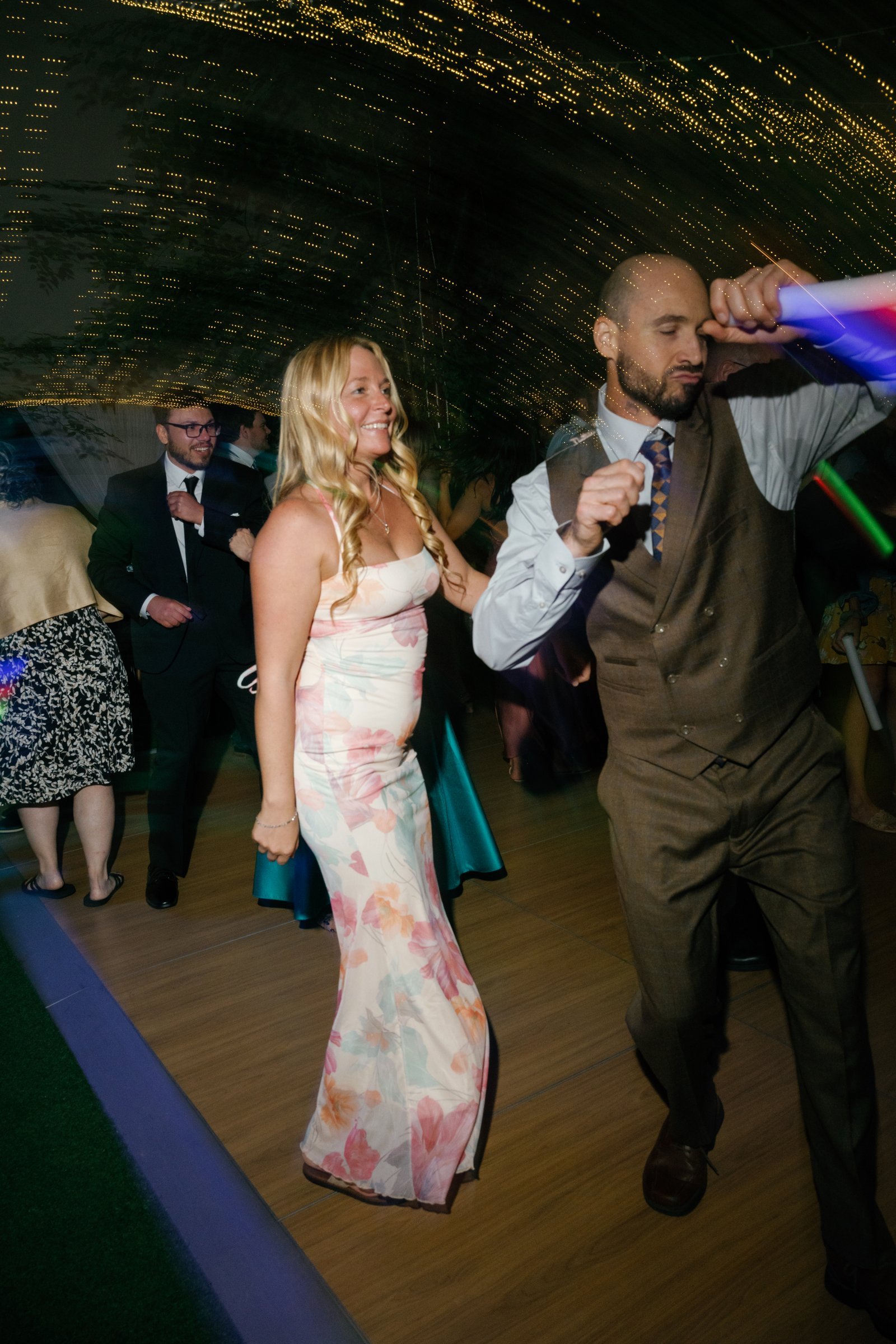 Guests dancing under the string lights