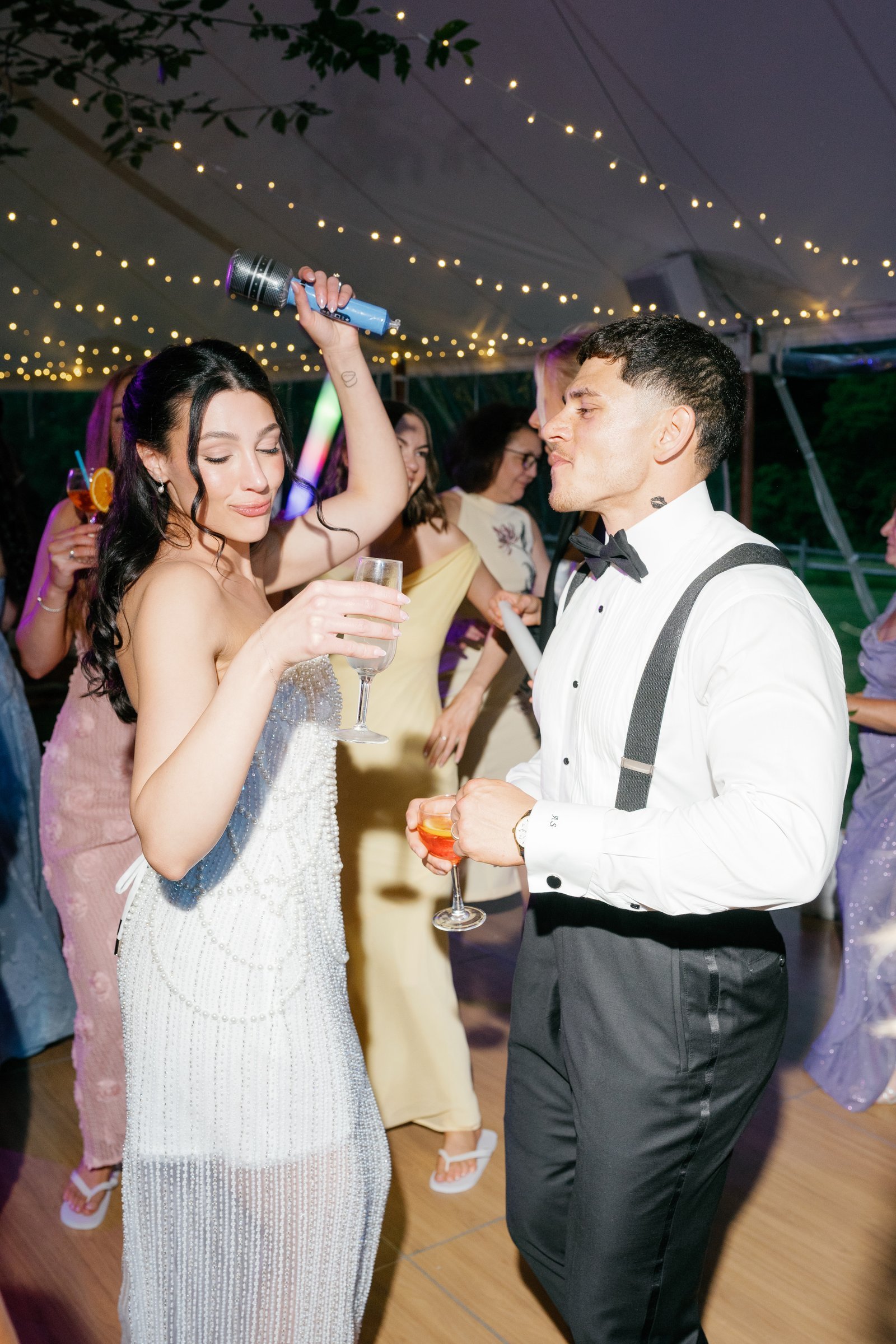 Kayla and Avery dancing under the string lights among the glow sticks