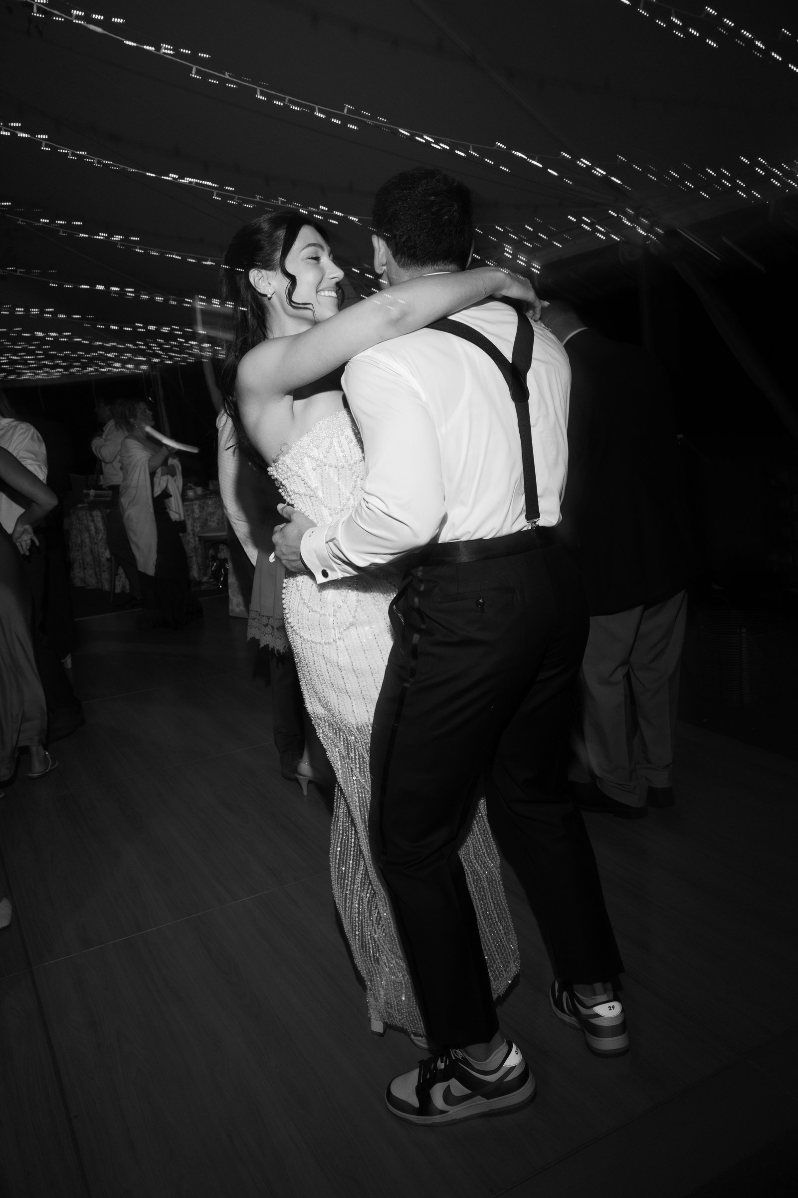 Kayla and Avery hugging on the dance floor, in black and white