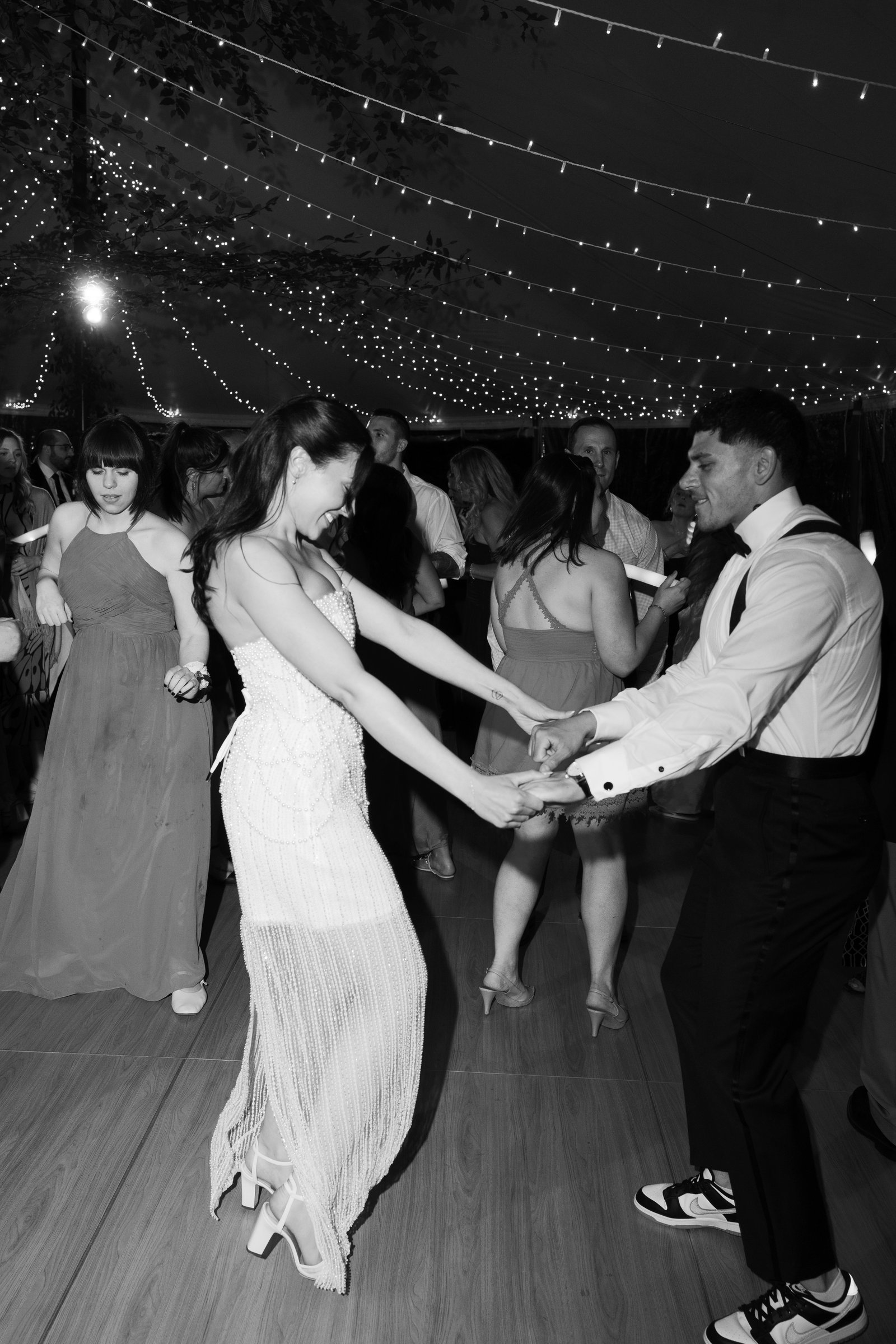Kayla and Avery dancing hand in hand, in black and white