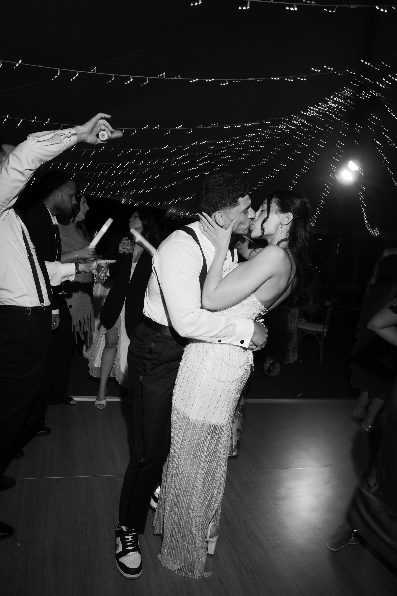 Kayla and Avery kissing on the dance floor at the end of the night, in black and white