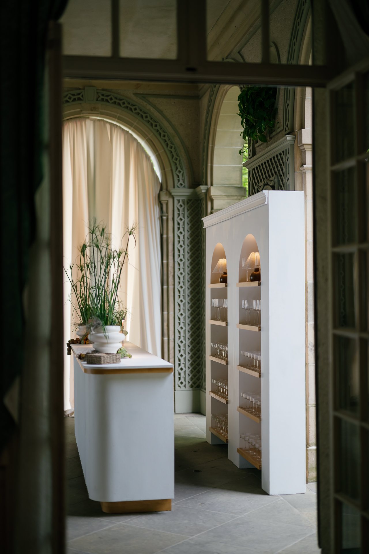 White bar and shelving under the stone arcade. Photographed by Shukhrat Kamalov.