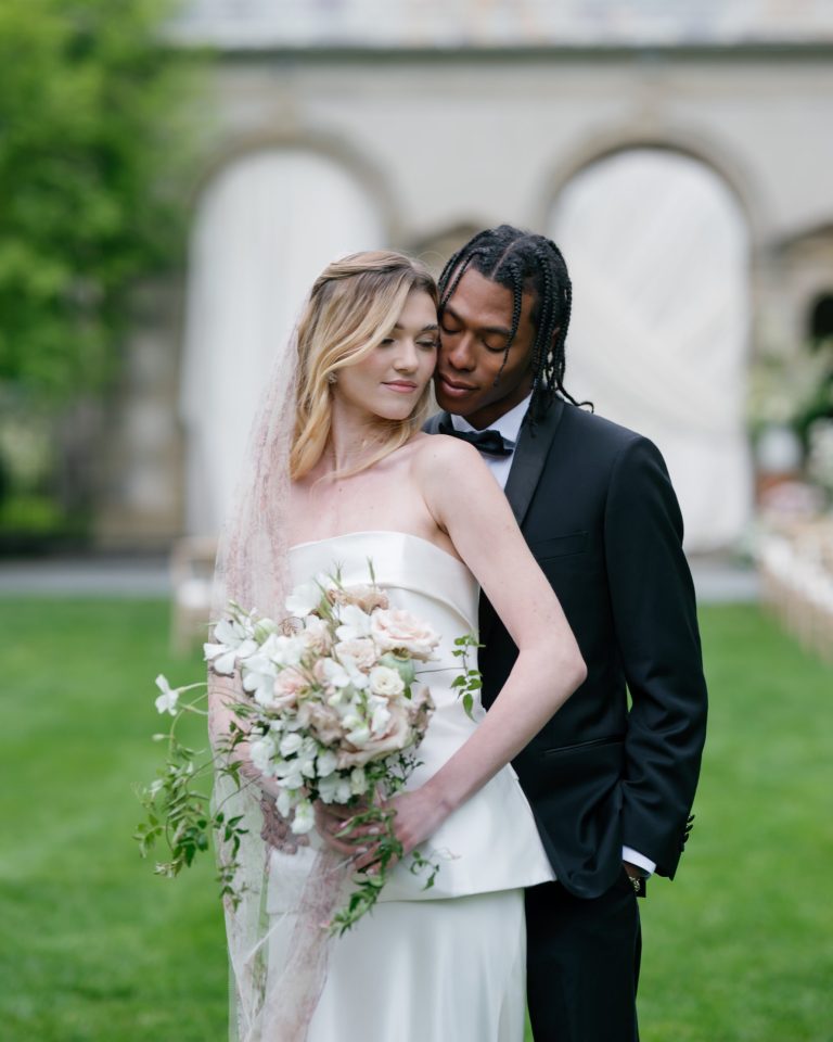 Couple in black tie with a floral-print veil, photographed in natural light by Shukhrat Kamalov