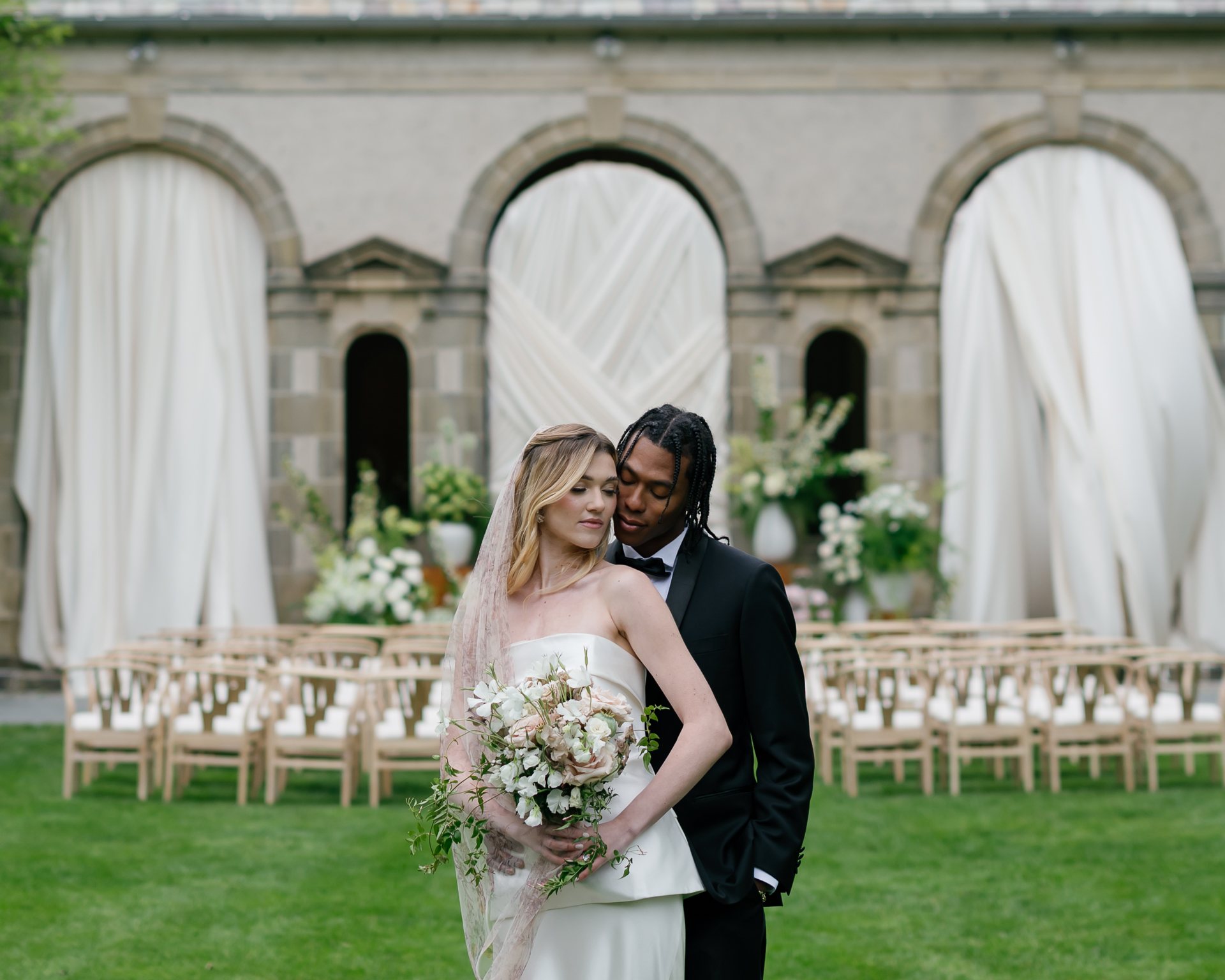Bride and groom at the draped arches of Glen Manor House. Photographed by Shukhrat Kamalov.