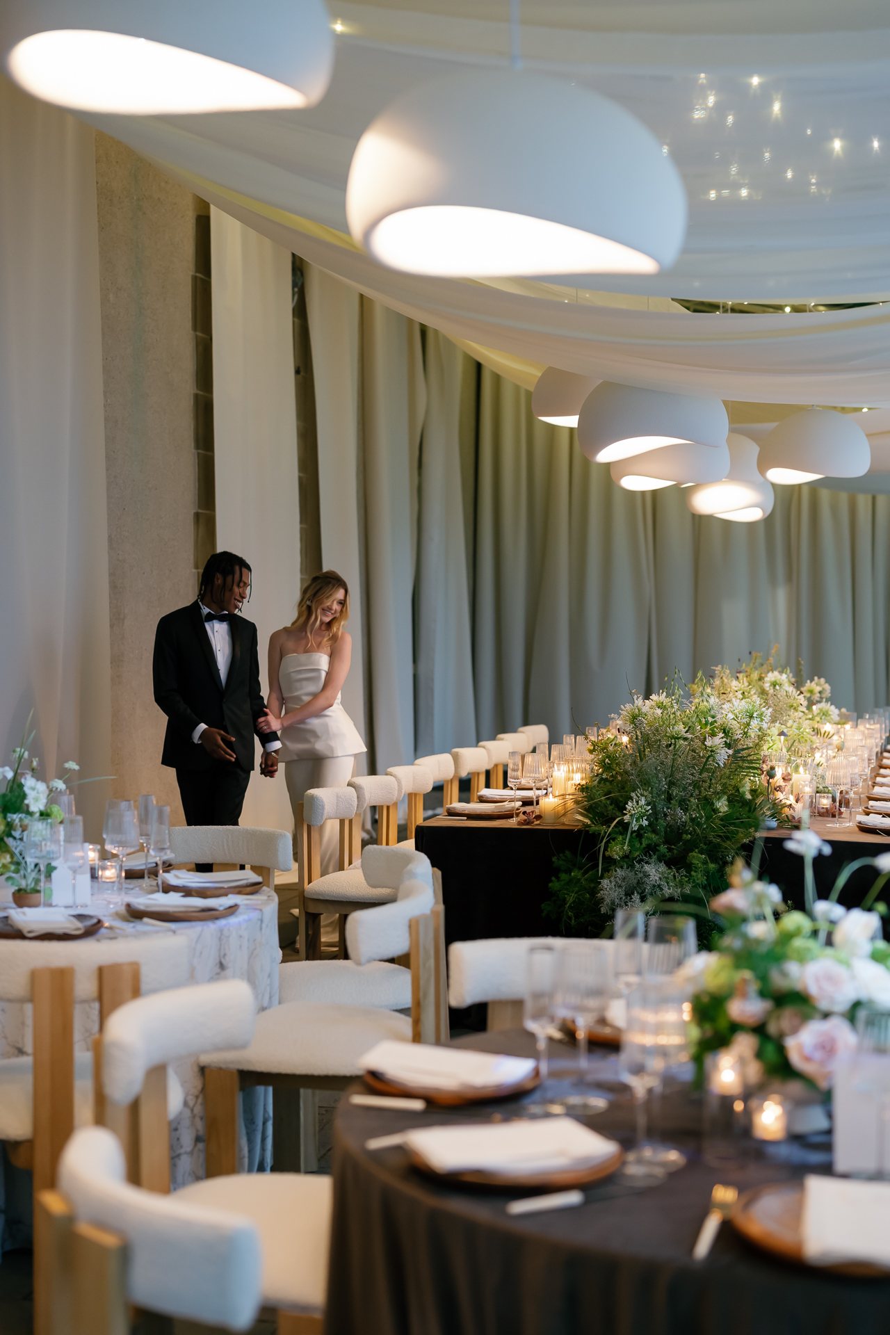 Bride and groom in the tent among the dinner tables. Photographed by Shukhrat Kamalov.
