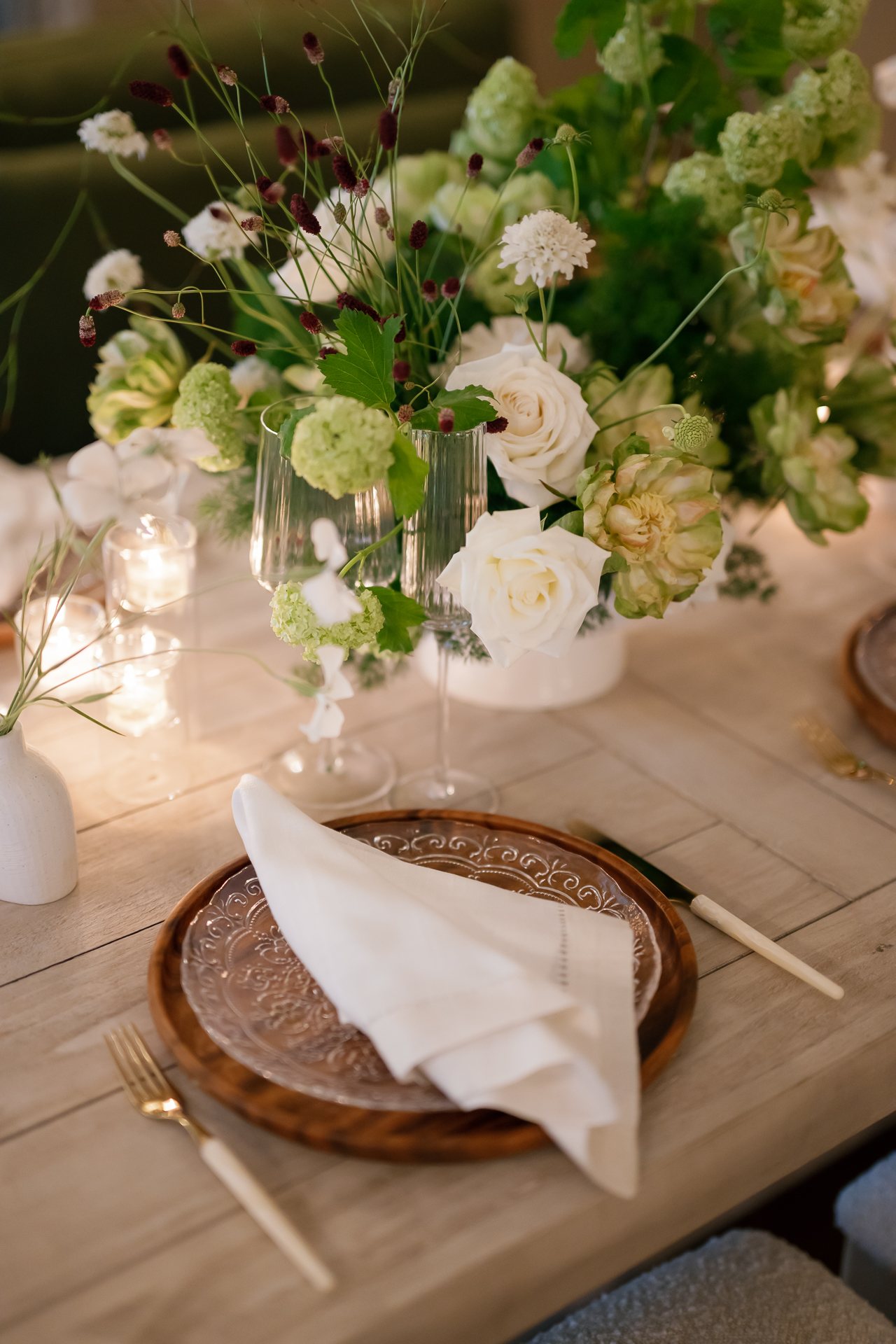 Dining room place setting with green and white florals. Photographed by Shukhrat Kamalov.