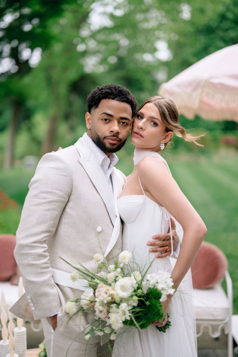 Couple in a linen suit and white gown under a garden umbrella, natural light, by Shukhrat Kamalov