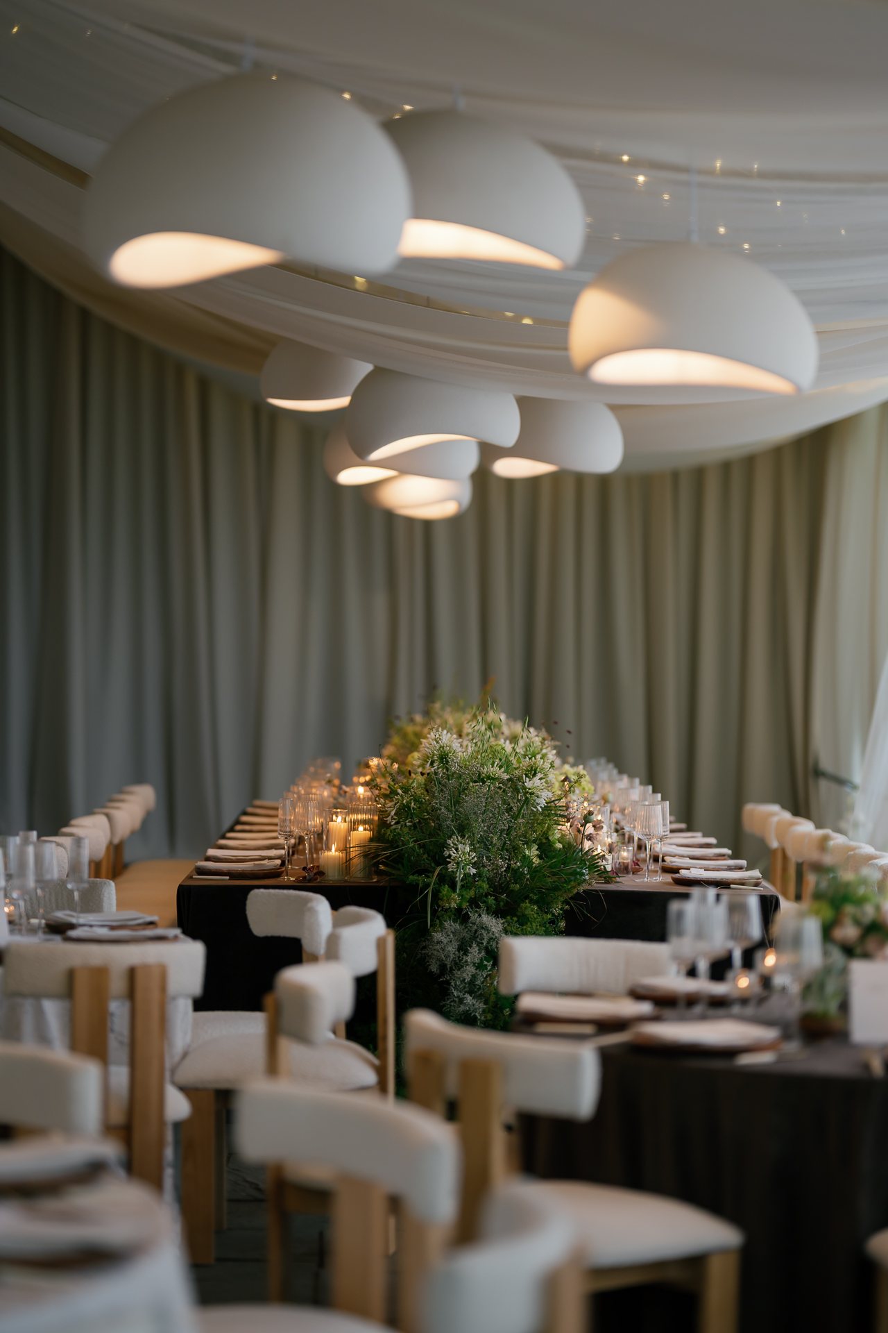 Pendant lights over the dinner tables in the tent. Photographed by Shukhrat Kamalov.