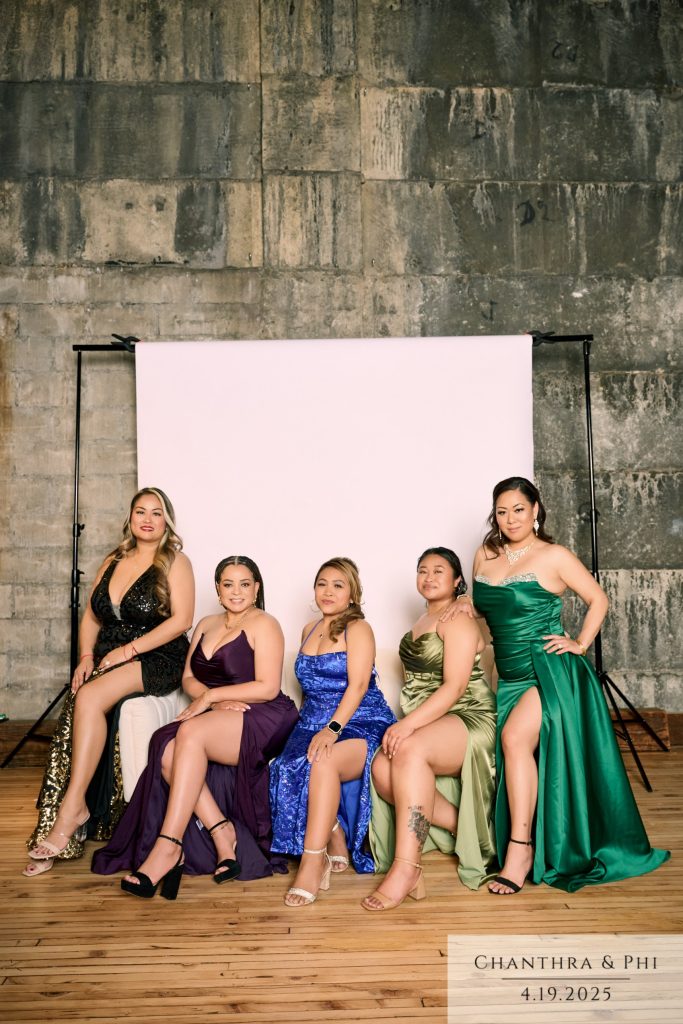 Five bridesmaids in satin gowns at the Portrait Lounge backdrop